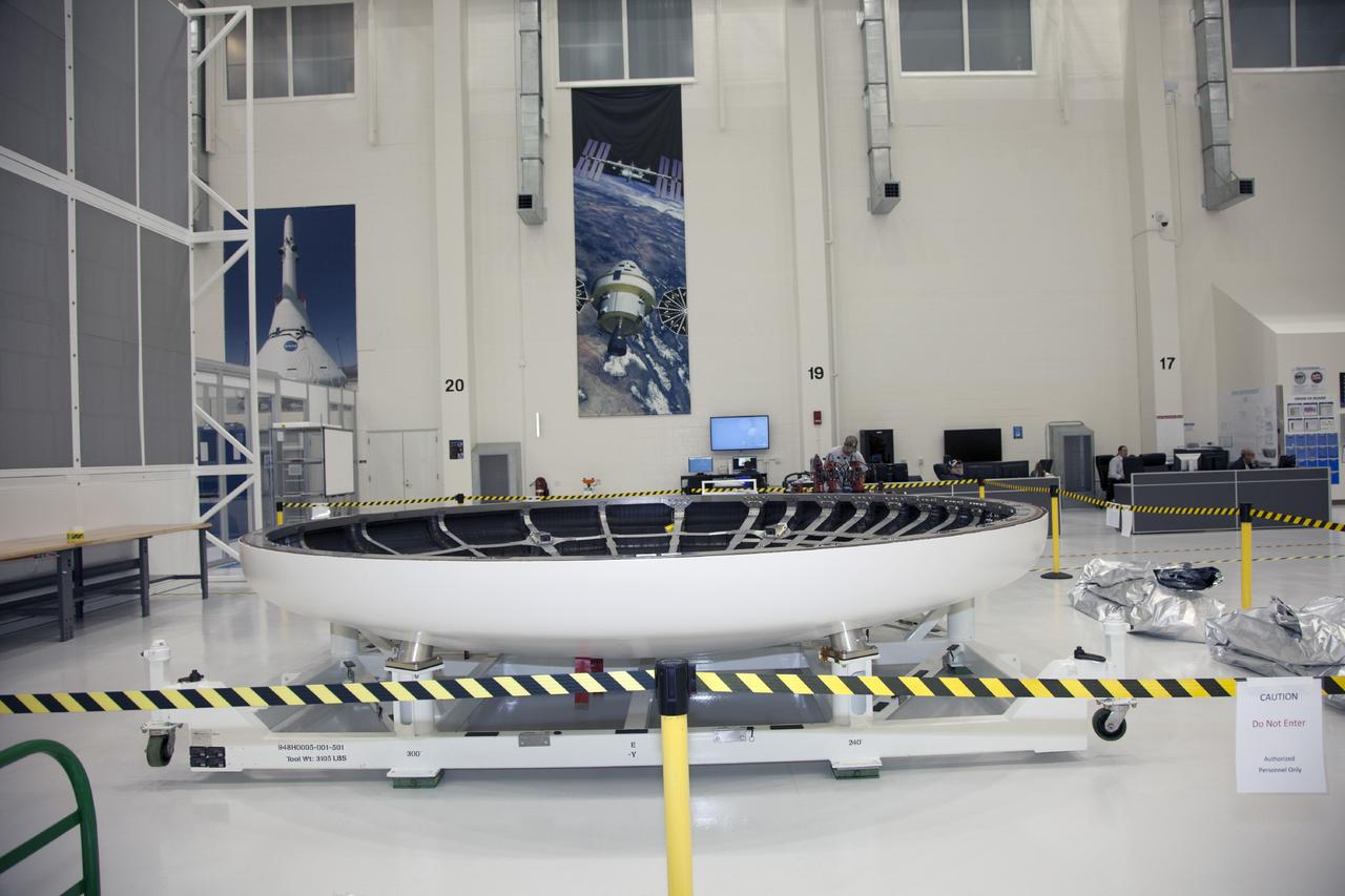 CAPE CANAVERAL, Fla. -- The heat shield for the Orion spacecraft has been placed on a work stand inside the Operations and Checkout Building high bay at NASA’s Kennedy Space Center in Florida. The heat shield arrived at Kennedy’s Shuttle Landing Facility on Dec. 5 on NASA’s Super Guppy aircraft. The largest of its kind ever built, the heat shield is planned for installation on the Orion crew module in March 2014.    The Orion spacecraft is being prepared for its first unpiloted flight test, Exploration Flight Test-1, or EFT-1, scheduled for launch atop a Delta IV rocket in September 2014. The Orion spacecraft is designed to carry astronauts to destinations not yet explored by humans. It will have emergency abort capability, sustain the crew during space travel and provide safe re-entry from deep space return velocities. Orion is scheduled to launch atop NASA’s Space Launch System rocket in 2017. For more information, visit http://www.nasa.gov/orion. Photo credit: NASA/Mike Chambers