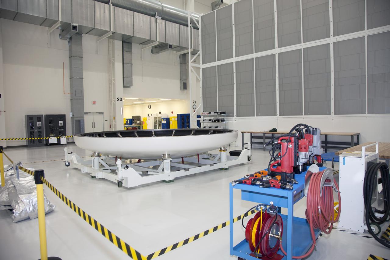 CAPE CANAVERAL, Fla. -- The heat shield for the Orion spacecraft has been placed on a work stand inside the Operations and Checkout Building high bay at NASA’s Kennedy Space Center in Florida. The heat shield arrived at Kennedy’s Shuttle Landing Facility on Dec. 5 on NASA’s Super Guppy aircraft. The largest of its kind ever built, the heat shield is planned for installation on the Orion crew module in March 2014.    The Orion spacecraft is being prepared for its first unpiloted flight test, Exploration Flight Test-1, or EFT-1, scheduled for launch atop a Delta IV rocket in September 2014. The Orion spacecraft is designed to carry astronauts to destinations not yet explored by humans. It will have emergency abort capability, sustain the crew during space travel and provide safe re-entry from deep space return velocities. Orion is scheduled to launch atop NASA’s Space Launch System rocket in 2017. For more information, visit http://www.nasa.gov/orion. Photo credit: NASA/Mike Chambers