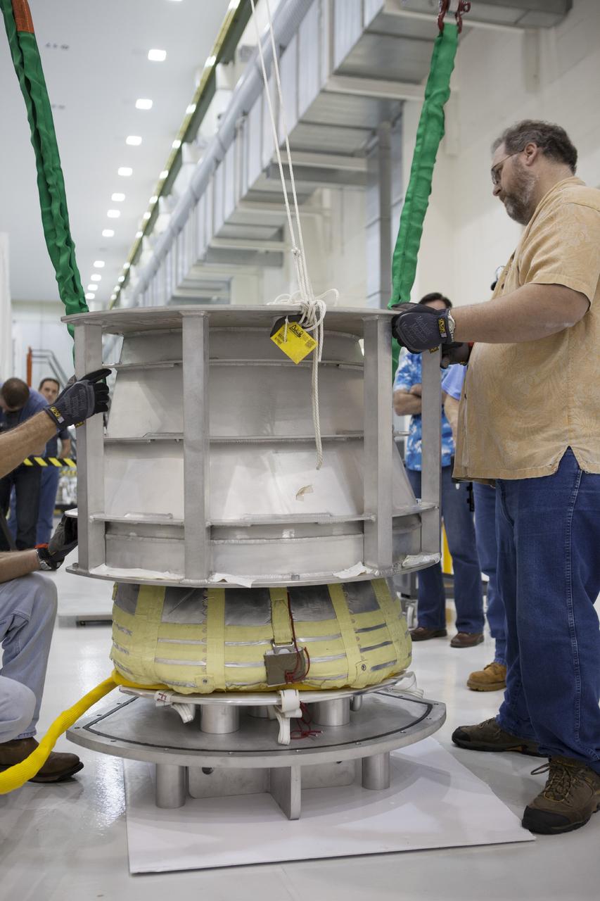 CAPE CANAVERAL, Fla. -- Inside the Operations and Checkout Building high bay at NASA’s Kennedy Space Center in Florida, a crane is used to lift the shipping container off of one of the three main parachutes for the Orion spacecraft. The parachute will be prepared for installation on Orion.     The Orion spacecraft is being prepared for its first unpiloted flight test, Exploration Flight Test-1, or EFT-1, scheduled for launch atop a Delta IV rocket in September 2014. The Orion spacecraft is designed to carry astronauts to destinations not yet explored by humans. It will have emergency abort capability, sustain the crew during space travel and provide safe re-entry from deep space return velocities. Orion is scheduled to launch atop NASA’s Space Launch System rocket in 2017. For more information, visit http://www.nasa.gov/orion. Photo credit: NASA/Kim Shiflett