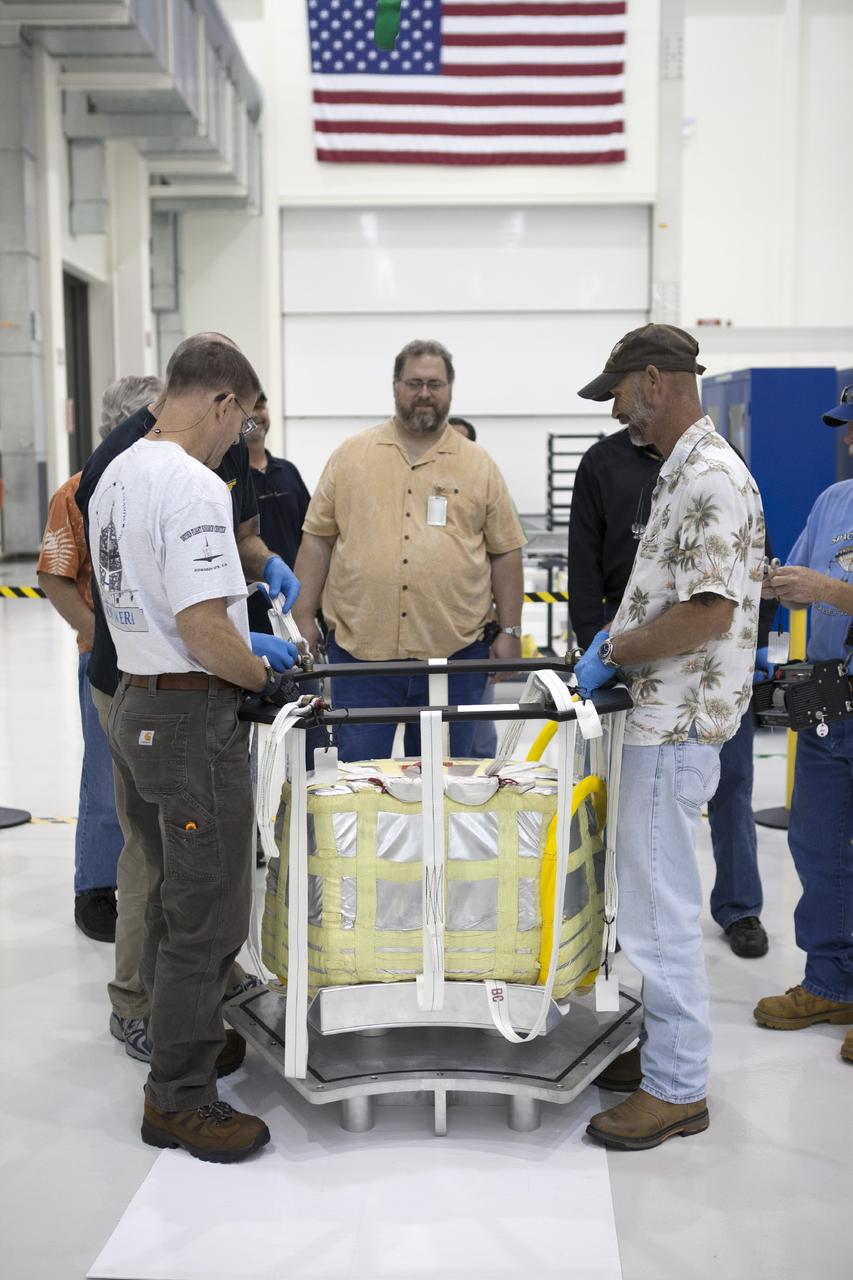 CAPE CANAVERAL, Fla. -- Inside the Operations and Checkout Building high bay at NASA’s Kennedy Space Center in Florida, technicians prepare the main parachute for the Orion spacecraft for lifting by crane. The parachute will be prepared for installation on Orion.     The Orion spacecraft is being prepared for its first unpiloted flight test, Exploration Flight Test-1, or EFT-1, scheduled for launch atop a Delta IV rocket in September 2014. The Orion spacecraft is designed to carry astronauts to destinations not yet explored by humans. It will have emergency abort capability, sustain the crew during space travel and provide safe re-entry from deep space return velocities. Orion is scheduled to launch atop NASA’s Space Launch System rocket in 2017. For more information, visit http://www.nasa.gov/orion. Photo credit: NASA/Kim Shiflett