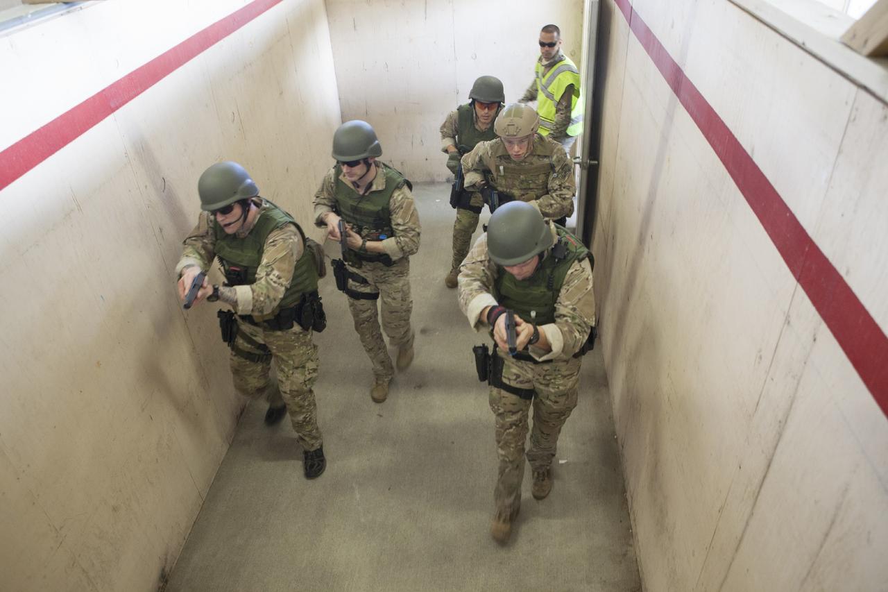 CAPE CANAVERAL, Fla. – At NASA’s Protective Services Training Academy at Kennedy Space Center in Florida, members of the Emergency Response Team, or ERT, participate in specialized training simulations in order to keep their skills current. They are wearing full protective gear and carrying non-lethal firearms, which are denoted in blue, for the training exercises.    Recently, eight members of the ERT competed in the 31st Annual SWAT Roundup International competition in Orlando, Fla., and received recognition by placing in the top five overall.  In keeping with NASA’s commitment to safety and security of workforce and assets, the ERT is part of Kennedy’s security team and is trained to respond in the event of an emergency at the center.  Photo credit: NASA/Dimitri Gerondidakis