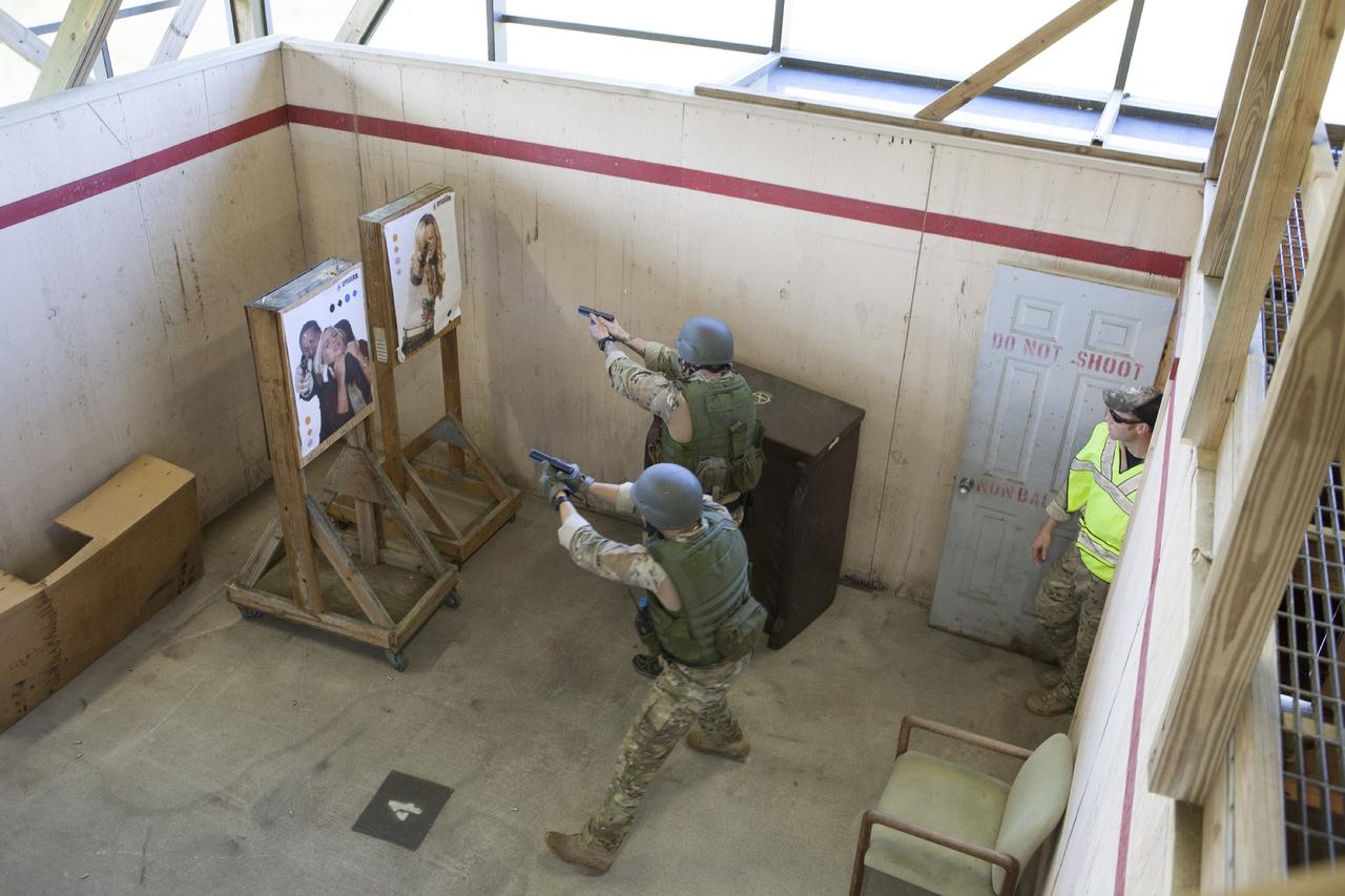 CAPE CANAVERAL, Fla. – At NASA’s Protective Services Training Academy at Kennedy Space Center in Florida, two members of the Emergency Response Team, or ERT, participate in specialized training simulations in order to keep their skills current as a training supervisor monitors the procedures. They are wearing full protective gear and carrying non-lethal firearms, which are denoted in blue, for the training exercises.    Recently, eight members of the ERT competed in the 31st Annual SWAT Roundup International competition in Orlando, Fla., and received recognition by placing in the top five overall.  In keeping with NASA’s commitment to safety and security of workforce and assets, the ERT is part of Kennedy’s security team and is trained to respond in the event of an emergency at the center.  Photo credit: NASA/Dimitri Gerondidakis