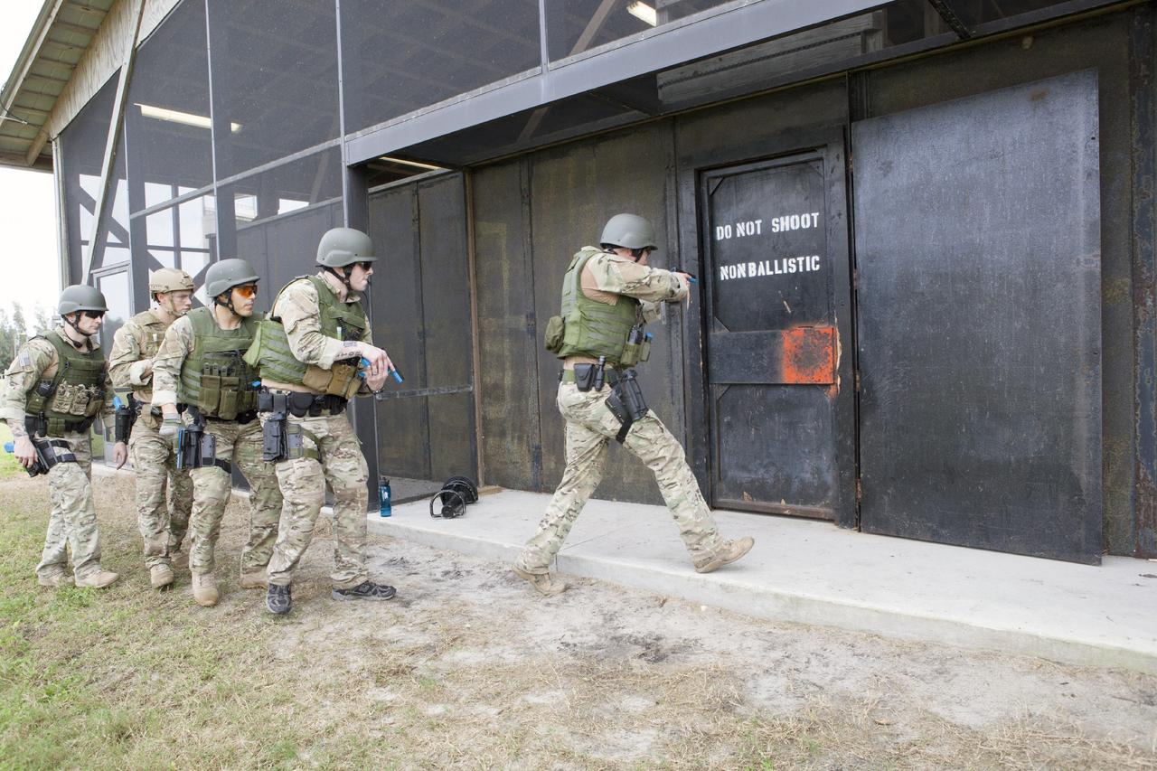 CAPE CANAVERAL, Fla. – At NASA’s Protective Services Training Academy at Kennedy Space Center in Florida, members of the Emergency Response Team, or ERT, participate in specialized training simulations in order to keep their skills current. They are wearing full protective gear and carrying non-lethal firearms, which are denoted in blue, for the training exercises.    Recently, eight members of the ERT competed in the 31st Annual SWAT Roundup International competition in Orlando, Fla., and received recognition by placing in the top five overall.  In keeping with NASA’s commitment to safety and security of workforce and assets, the ERT is part of Kennedy’s security team and is trained to respond in the event of an emergency at the center.  Photo credit: NASA/Dimitri Gerondidakis
