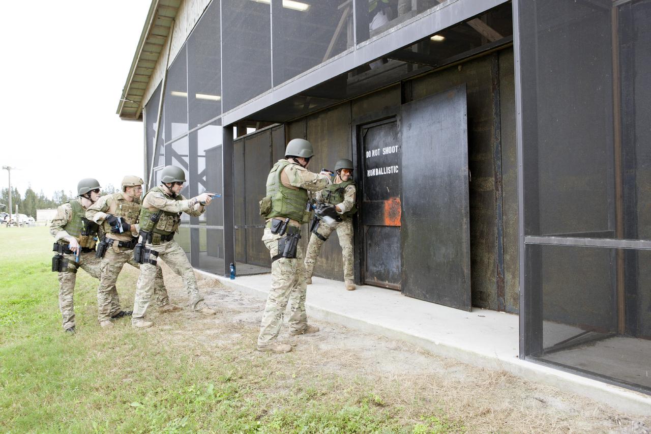 CAPE CANAVERAL, Fla. – At NASA’s Protective Services Training Academy at Kennedy Space Center in Florida, members of the Emergency Response Team, or ERT, participate in specialized training simulations in order to keep their skills current. They are wearing full protective gear and carrying non-lethal firearms, which are denoted in blue, for the training exercises.    Recently, eight members of the ERT competed in the 31st Annual SWAT Roundup International competition in Orlando, Fla., and received recognition by placing in the top five overall.  In keeping with NASA’s commitment to safety and security of workforce and assets, the ERT is part of Kennedy’s security team and is trained to respond in the event of an emergency at the center.  Photo credit: NASA/Dimitri Gerondidakis