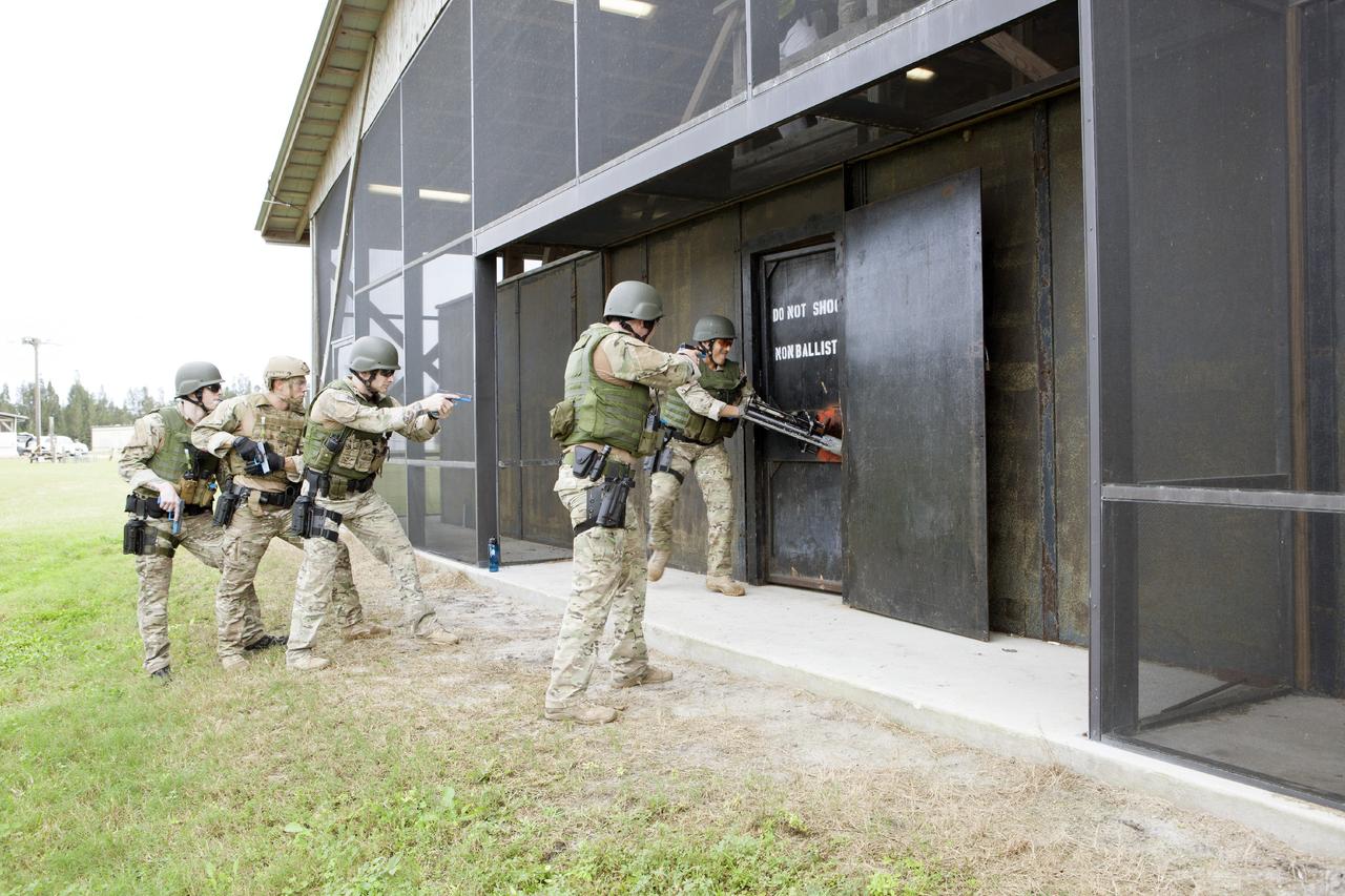 CAPE CANAVERAL, Fla. – At NASA’s Protective Services Training Academy at Kennedy Space Center in Florida, members of the Emergency Response Team, or ERT, participate in specialized training simulations in order to keep their skills current. They are wearing full protective gear and carrying non-lethal firearms, which are denoted in blue, for the training exercises.    Recently, eight members of the ERT competed in the 31st Annual SWAT Roundup International competition in Orlando, Fla., and received recognition by placing in the top five overall.  In keeping with NASA’s commitment to safety and security of workforce and assets, the ERT is part of Kennedy’s security team and is trained to respond in the event of an emergency at the center.  Photo credit: NASA/Dimitri Gerondidakis