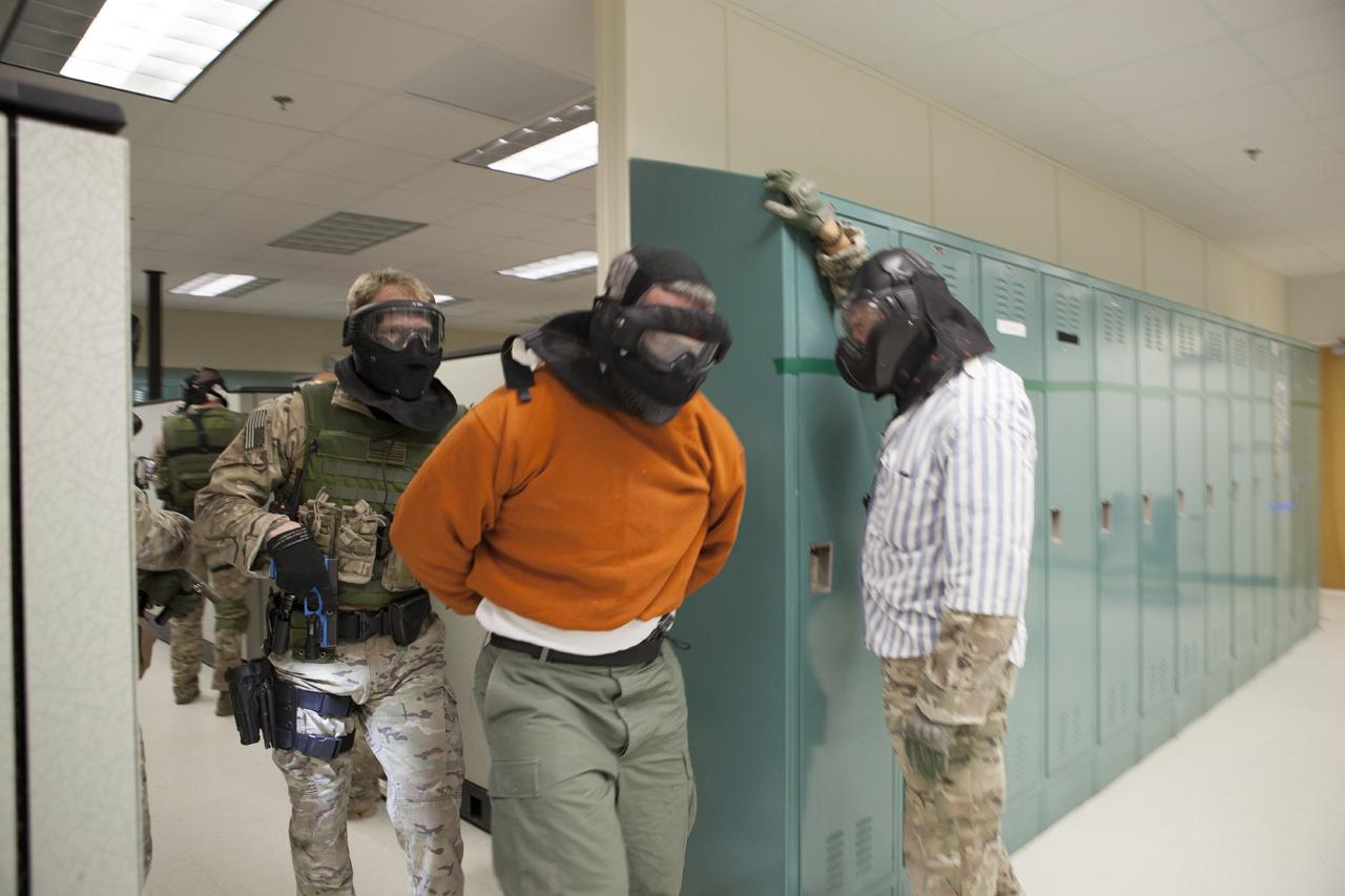 CAPE CANAVERAL, Fla. – At a training location near Launch Complex 39 at NASA’s Kennedy Space Center in Florida, members of the Emergency Response Team, or ERT, participate in specialized training simulations in order to keep their skills current. They are wearing full protective gear and carrying non-lethal firearms, which are denoted in blue, for the training exercises. Often, ERT leadership serves as simulated suspects to add realism to the training exercises.     Recently, eight members of the ERT competed in the 31st Annual SWAT Roundup International competition in Orlando, Fla., and received recognition by placing in the top five overall.  In keeping with NASA’s commitment to safety and security of workforce and assets, the ERT is part of Kennedy’s security team and is trained to respond in the event of an emergency at the center.  Photo credit: NASA/Daniel Casper