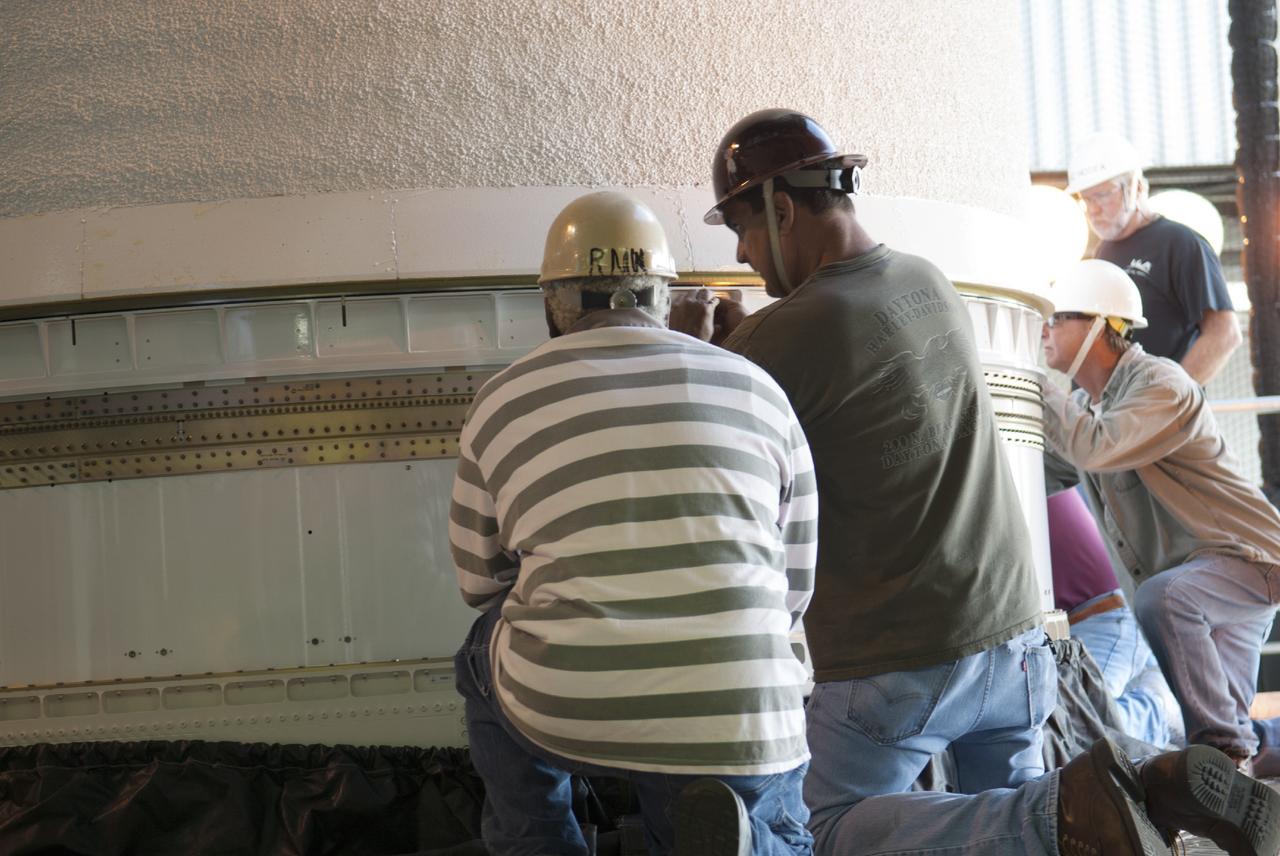 CAPE CANAVERAL, Fla. – At Cape Canaveral Air Force Station's Launch Complex 41, engineers and technicians inspect a Centaur second stage that was just stacked atop a United Launch Alliance Atlas V rocket that will be used to boost the Tracking and Data Relay Satellite, or TDRS-L, spacecraft to orbit. TDRS-L is the second of three next-generation satellites designed to ensure vital operational continuity for the NASA Space Network. It is scheduled to launch from Cape Canaveral's Space Launch Complex 41 atop an Atlas V rocket in January 2014. The current Tracking and Data Relay Satellite system consists of eight in-orbit satellites distributed to provide near continuous information relay service to missions such as the Hubble Space Telescope and International Space Station. For more information, visit: http://www.nasa.gov/content/tracking-and-data-relay-satellite-tdrs/ Photo credit: NASA/Charisse Nahser