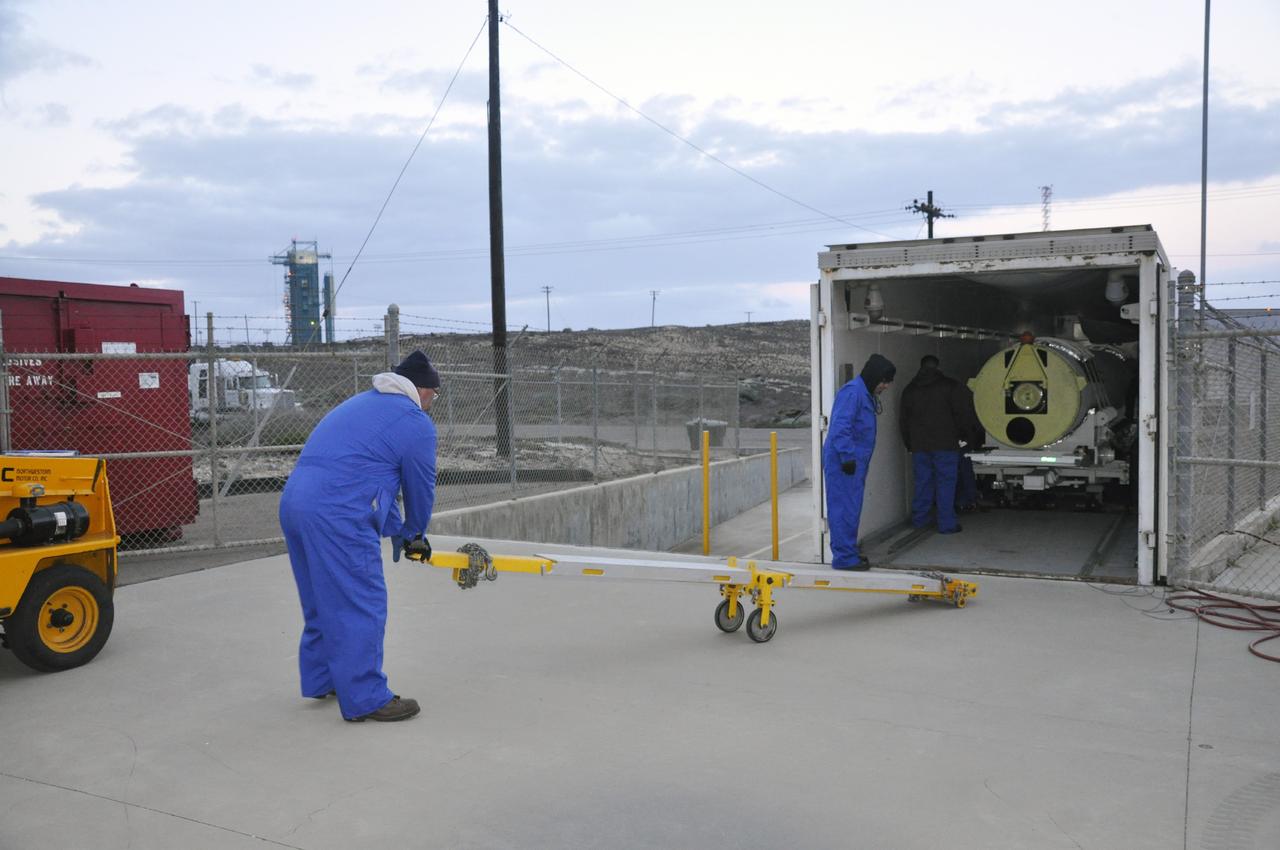 VANDENBERG AIR FORCE BASE, Calif. -- Personnel prepare to offload a solid rocket motor from its delivery truck following its arrival at Vandenberg Air Force Base in California. The motor will be attached to the United Launch Alliance Delta II rocket slated to launch NASA's Orbiting Carbon Observatory-2, or OCO-2 spacecraft in July 2014. Space Launch Complex 2, where OCO-2 will be launched, can be seen in the background.      OCO-2 will collect precise global measurements of carbon dioxide  in the Earth's atmosphere. Scientists will analyze this data to improve our understanding of the natural processes and human activities that regulate the abundance and distribution of this important atmospheric gas.  Photo credit: NASA/Randy Beaudoin