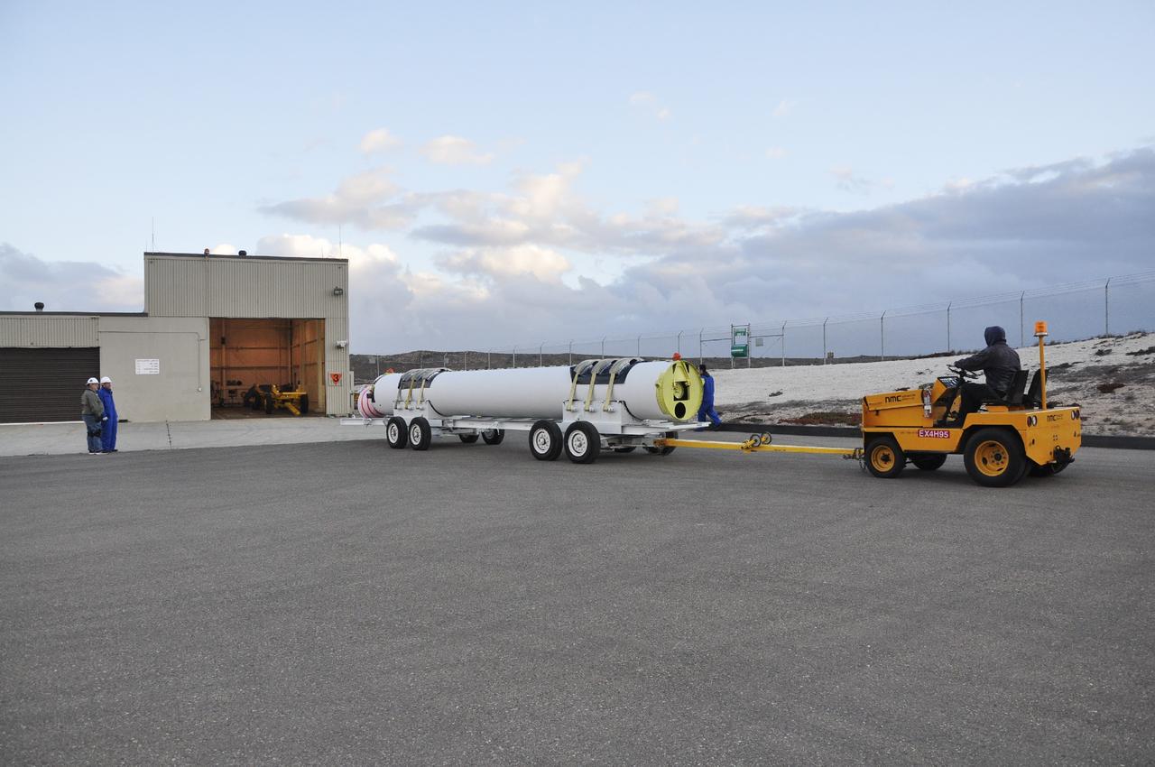 VANDENBERG AIR FORCE BASE, Calif. -- A solid rocket rocket motor is maneuvered toward the open high bay door of the Solid Rocket Motor Processing Facility at Vandenberg Air Force Base in California. The motor will be attached to the United Launch Alliance Delta II rocket slated to launch NASA's Orbiting Carbon Observatory-2, or OCO-2, spacecraft in July 2014.    OCO-2 will collect precise global measurements of carbon dioxide  in the Earth's atmosphere. Scientists will analyze this data to improve our understanding of the natural processes and human activities that regulate the abundance and distribution of this important atmospheric gas.  Photo credit: NASA/Randy Beaudoin