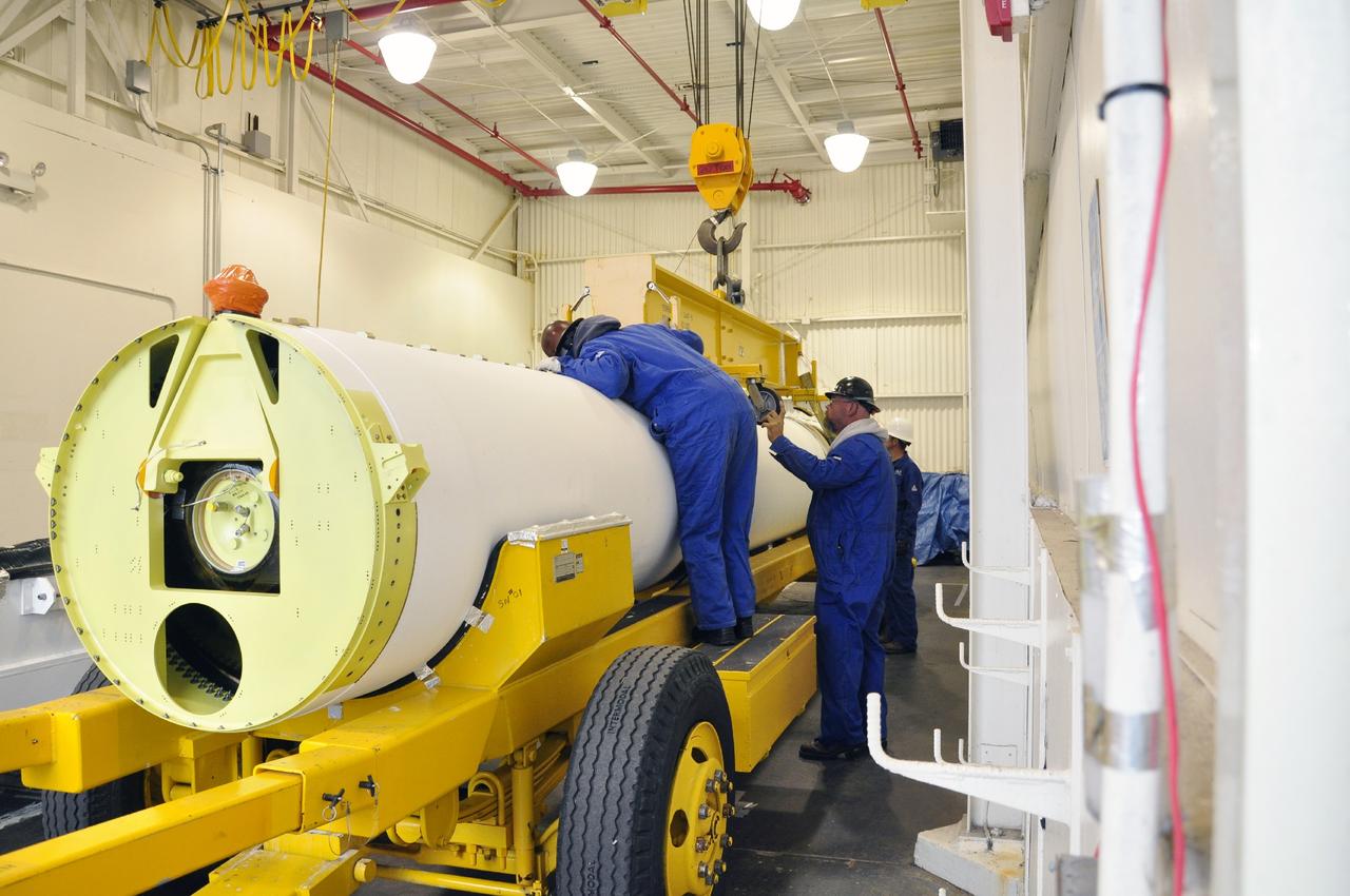 VANDENBERG AIR FORCE BASE, Calif. -- A solid rocket motor is secured to a transporter inside the Solid Rocket Motor Processing Facility at Vandenberg Air Force Base in California. The motor will be attached to the United Launch Alliance Delta II rocket slated to launch NASA's Orbiting Carbon Observatory-2, or OCO-2, spacecraft in July 2014.    OCO-2 will collect precise global measurements of carbon dioxide  in the Earth's atmosphere. Scientists will analyze this data to improve our understanding of the natural processes and human activities that regulate the abundance and distribution of this important atmospheric gas.  Photo credit: NASA/Randy Beaudoin