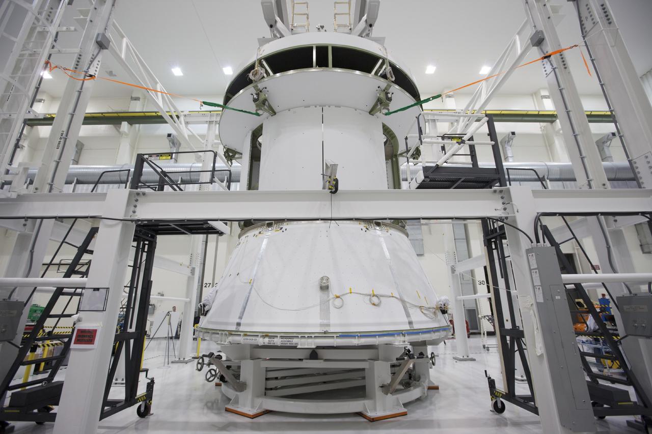 CAPE CANAVERAL, Fla. – Inside the Operations and Checkout Building at NASA’s Kennedy Space Center in Florida, the spacecraft adapter cone for Orion has been positioned underneath the service module, which is suspended above the floor by a movable crane. The service module will be attached to the adapter cone. Orion is the exploration spacecraft designed to carry astronauts to destinations not yet explored by humans, including an asteroid and Mars. It will have emergency abort capability, sustain the crew during space travel and provide safe re-entry from deep space return velocities. The first unpiloted test flight of the Orion is scheduled to launch in 2014 atop a Delta IV rocket and in 2017 on NASA’s Space Launch System rocket. For more information, visit http://www.nasa.gov/orion. Photo credit: NASA/Kim Shiflett