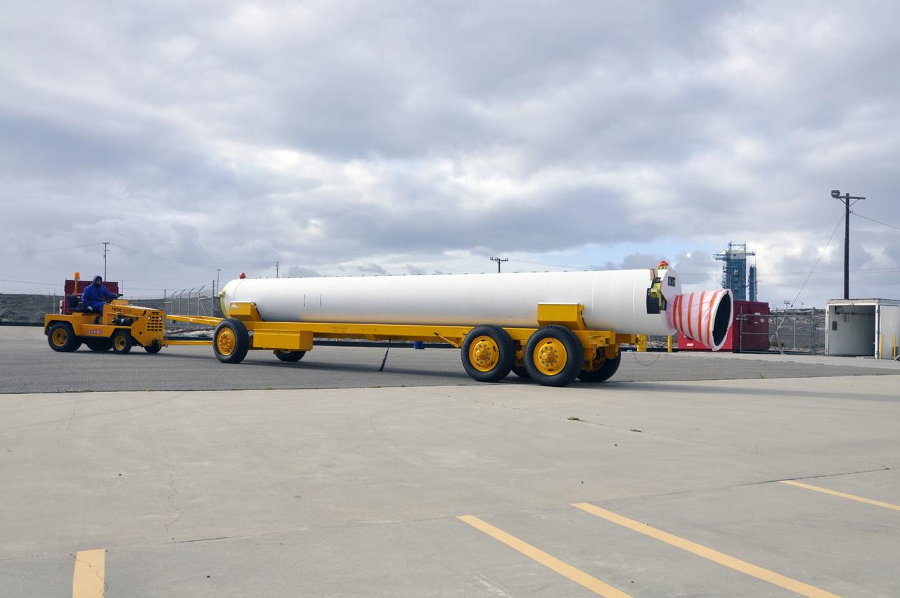 VANDENBERG AIR FORCE BASE, Calif. -- A solid rocket motor is moved on a transporter to the Solid Rocket Motor Processing Facility at Vandenberg Air Force Base in California. The motor will be attached to the United Launch Alliance Delta II rocket slated to launch NASA's Orbiting Carbon Observatory-2, or OCO-2, spacecraft in July 2014. Space Launch Complex-2, where the mission will launch from, can be seen in the background. OCO-2 will collect precise global measurements of carbon dioxide in the Earth's atmosphere. Scientists will analyze this data to improve our understanding of the natural processes and human activities that regulate the abundance and distribution of this important atmospheric gas. Photo credit: NASA/Randy Beaudoin