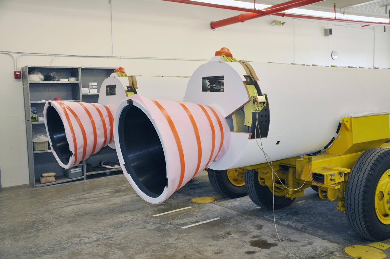 VANDENBERG AIR FORCE BASE, Calif. – A pair of solid rocket motors on transporters inside the Solid Rocket Motor Processing Facility at Vandenberg Air Force Base in California. The motors will be attached to the United Launch Alliance Delta II rocket slated to launch NASA's Orbiting Carbon Observatory-2, or OCO-2, spacecraft in July 2014. OCO-2 will collect precise global measurements of carbon dioxide in the Earth's atmosphere. Scientists will analyze this data to improve our understanding of the natural processes and human activities that regulate the abundance and distribution of this important atmospheric gas. Photo credit: NASA/Randy Beaudoin