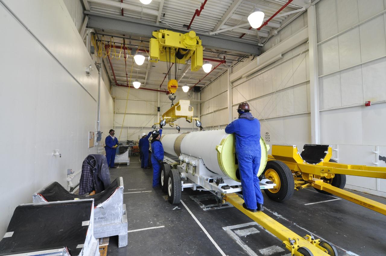 VANDENBERG AIR FORCE BASE, Calif. – Technicians prepare to move a solid rocket motor to a different transporter inside the Solid Rocket Motor Processing Facility at Vandenberg Air Force Base in California. The motor will be attached to the United Launch Alliance Delta II rocket slated to launch NASA's Orbiting Carbon Observatory-2, or OCO-2, spacecraft in July 2014. OCO-2 will collect precise global measurements of carbon dioxide in the Earth's atmosphere. Scientists will analyze this data to improve our understanding of the natural processes and human activities that regulate the abundance and distribution of this important atmospheric gas. Photo credit: NASA/Randy Beaudoin