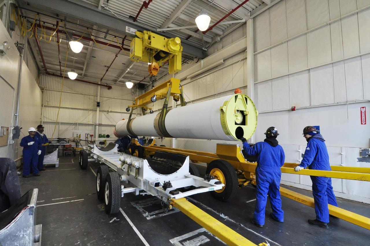 VANDENBERG AIR FORCE BASE, Calif. – Technicians move a solid rocket motor to a different transporter inside the Solid Rocket Motor Processing Facility at Vandenberg Air Force Base in California. The motor will be attached to the United Launch Alliance Delta II rocket slated to launch NASA's Orbiting Carbon Observatory-2, or OCO-2, spacecraft in July 2014. OCO-2 will collect precise global measurements of carbon dioxide in the Earth's atmosphere. Scientists will analyze this data to improve our understanding of the natural processes and human activities that regulate the abundance and distribution of this important atmospheric gas. Photo credit: NASA/Randy Beaudoin