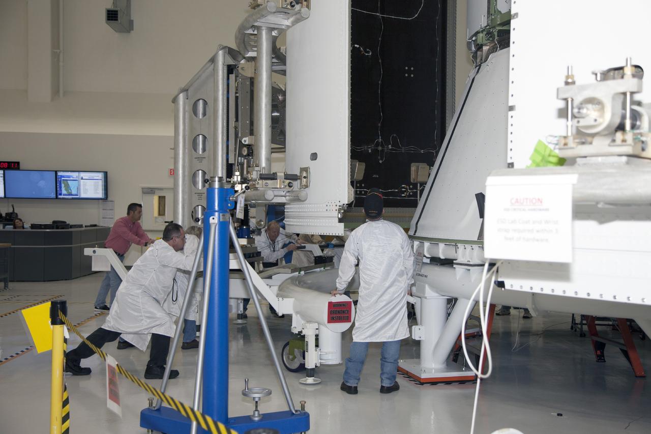 CAPE CANAVERAL, Fla. – Inside the Operations and Checkout Building high bay at NASA’s Kennedy Space Center in Florida, technicians use a special handling device to move the first of three fairings for installation on the service module for the Orion spacecraft. The Orion spacecraft is being prepared for its first unpiloted flight test, Exploration Flight Test-1, or EFT-1, scheduled for launch atop a Delta IV rocket in September 2014. The Orion spacecraft is designed to carry astronauts to destinations not yet explored by humans. It will have emergency abort capability, sustain the crew during space travel and provide safe re-entry from deep space return velocities. Orion is scheduled to launch atop NASA’s Space Launch System rocket in 2017. For more information, visit http://www.nasa.gov/orion. Photo credit: NASA/Daniel Casper