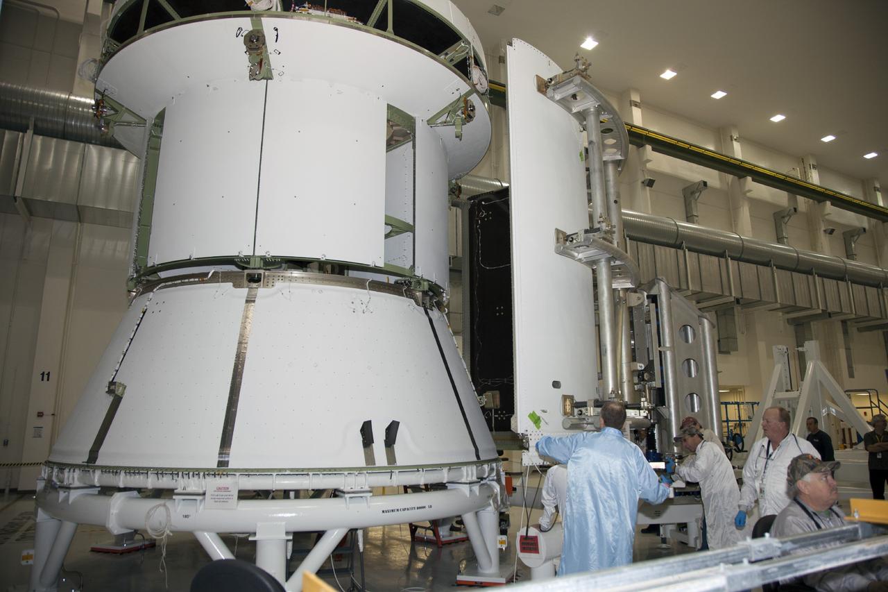 CAPE CANAVERAL, Fla. – Inside the Operations and Checkout Building high bay at NASA’s Kennedy Space Center in Florida, technicians use a special handling device to move the first of three fairings closer for installation on the service module for the Orion spacecraft. The Orion spacecraft is being prepared for its first unpiloted flight test, Exploration Flight Test-1, or EFT-1, scheduled for launch atop a Delta IV rocket in September 2014. The Orion spacecraft is designed to carry astronauts to destinations not yet explored by humans. It will have emergency abort capability, sustain the crew during space travel and provide safe re-entry from deep space return velocities. Orion is scheduled to launch atop NASA’s Space Launch System rocket in 2017. For more information, visit http://www.nasa.gov/orion. Photo credit: NASA/Daniel Casper