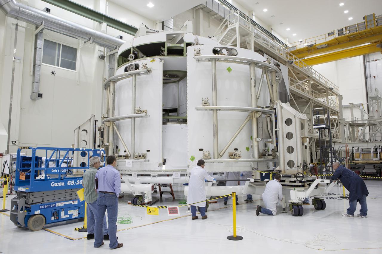 CAPE CANAVERAL, Fla. – Inside the Operations and Checkout Building high bay at NASA’s Kennedy Space Center in Florida, technicians use a special handling device to move the second of three fairings closer for installation on the service module for the Orion spacecraft.      The Orion spacecraft is being prepared for its first unpiloted flight test, Exploration Flight Test-1, or EFT-1, scheduled for launch atop a Delta IV rocket in September 2014. The Orion spacecraft is designed to carry astronauts to destinations not yet explored by humans. It will have emergency abort capability, sustain the crew during space travel and provide safe re-entry from deep space return velocities. Orion is scheduled to launch atop NASA’s Space Launch System rocket in 2017. For more information, visit http://www.nasa.gov/orion. Photo credit: NASA/Dimitri Gerondidakis