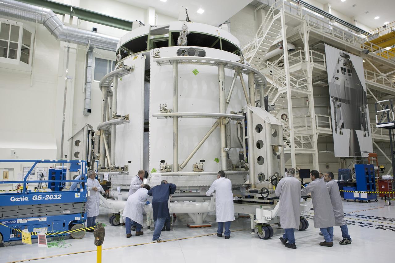 CAPE CANAVERAL, Fla. – Inside the Operations and Checkout Building high bay at NASA’s Kennedy Space Center in Florida, technicians use a special handling device to move the second of three fairings closer for installation on the service module for the Orion spacecraft.      The Orion spacecraft is being prepared for its first unpiloted flight test, Exploration Flight Test-1, or EFT-1, scheduled for launch atop a Delta IV rocket in September 2014. The Orion spacecraft is designed to carry astronauts to destinations not yet explored by humans. It will have emergency abort capability, sustain the crew during space travel and provide safe re-entry from deep space return velocities. Orion is scheduled to launch atop NASA’s Space Launch System rocket in 2017. For more information, visit http://www.nasa.gov/orion. Photo credit: NASA/Dimitri Gerondidakis