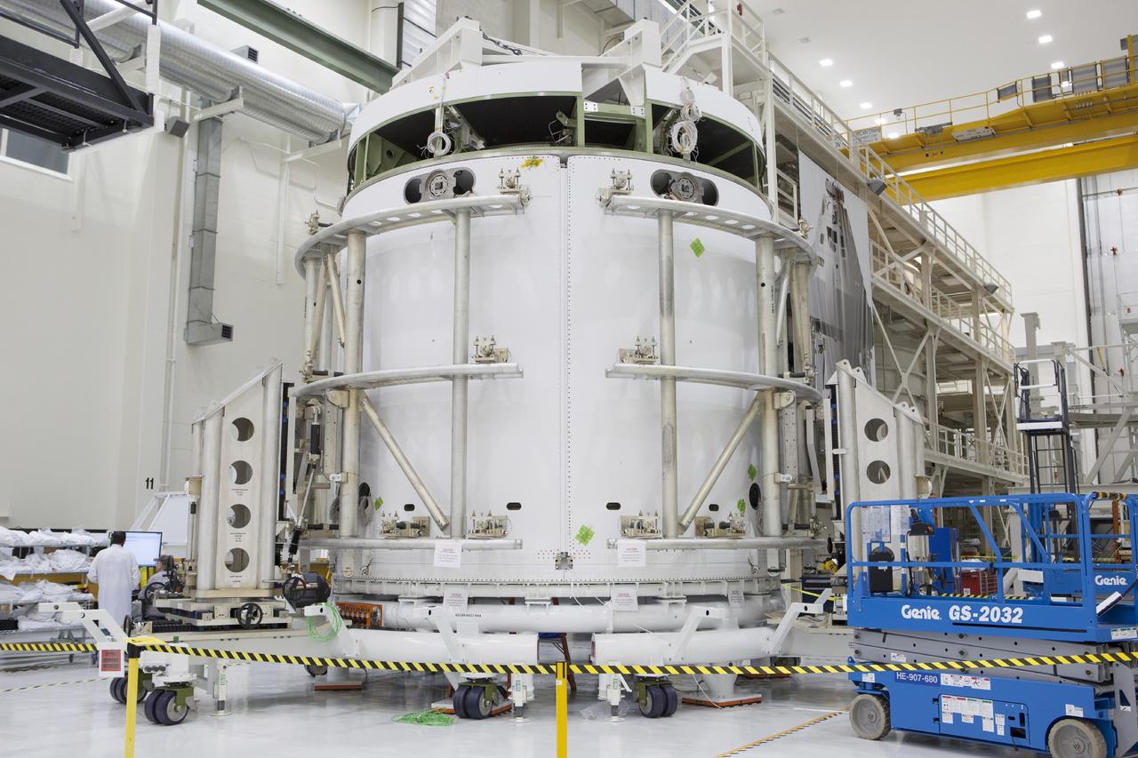 CAPE CANAVERAL, Fla. – Inside the Operations and Checkout Building high bay at NASA’s Kennedy Space Center in Florida, technicians have completed the installation of two of three fairings on the service module for the Orion spacecraft. The Orion spacecraft is being prepared for its first unpiloted flight test, Exploration Flight Test-1, or EFT-1, scheduled for launch atop a Delta IV rocket in September 2014. The Orion spacecraft is designed to carry astronauts to destinations not yet explored by humans. It will have emergency abort capability, sustain the crew during space travel and provide safe re-entry from deep space return velocities. Orion is scheduled to launch atop NASA’s Space Launch System rocket in 2017. For more information, visit http://www.nasa.gov/orion. Photo credit: NASA/Dimitri Gerondidakis
