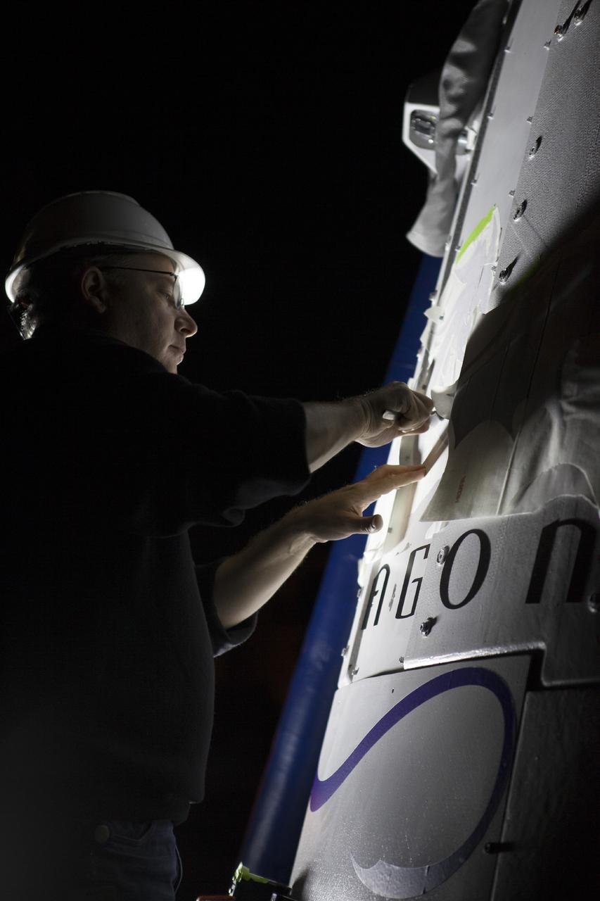 MORRO BAY, Calif. –  A SpaceX engineer prepares the SpaceX Dragon test article for a test that would enable evaluation of the spacecraft's parachute deployment system as part of a milestone under its Commercial Crew Integrated Capability agreement with NASA's Commercial Crew Program. The parachute test took place at Morro Bay, Calif. Photo credit: NASA/Kim Shiflett