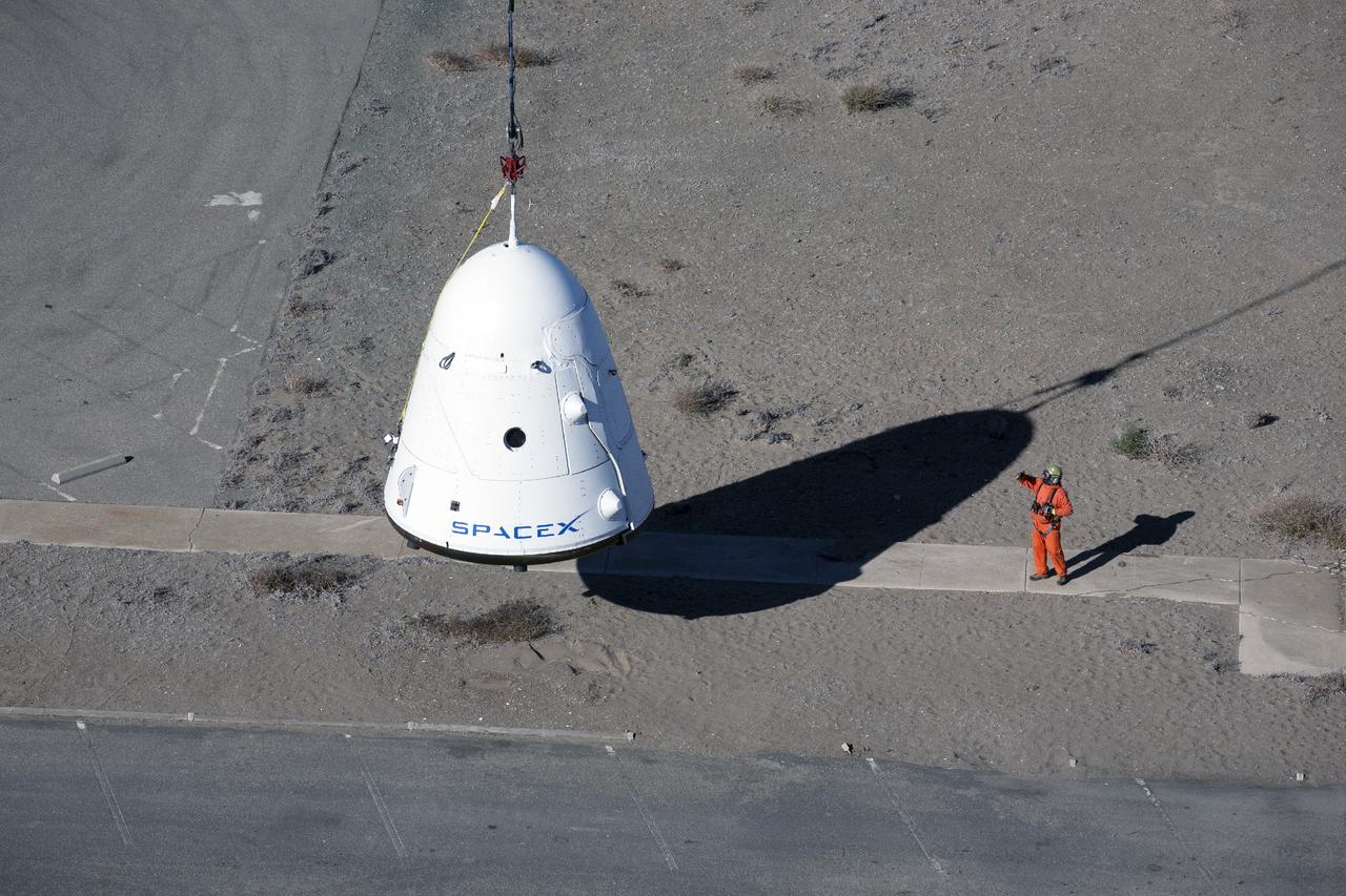 MORRO BAY, Calif. – A SpaceX Dragon test article is lifted under an Erickson Sky Crane helicopter before a test to evaluate the spacecraft's parachute deployment system as part of a milestone achievement under its Commercial Crew Integrated Capability agreement with NASA's Commercial Crew Program. The parachute test took place over the Pacific Ocean, off the coast of Morro Bay, Calif. Photo credit: NASA/Kim Shiflett