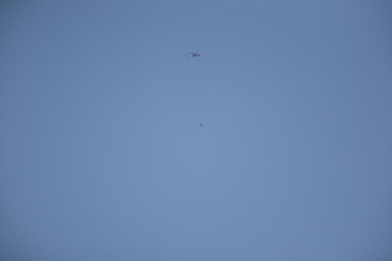 MORRO BAY, Calif. – The SpaceX Dragon test article tumbles over the Pacific Ocean, off the coast of Morro Bay, Calif., following its release for an Erickson Sky Crane helicopter. SpaceX engineers induced the tumble to evaluate the spacecraft's parachute deployment system in an emergency abort scenario. The test is part of a milestone under its Commercial Crew Integrated Capability agreement with NASA's Commercial Crew Program. Photo credit: NASA/Kim Shiflett