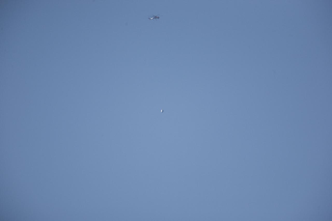 MORRO BAY, Calif. – The SpaceX Dragon test article tumbles over the Pacific Ocean, off the coast of Morro Bay, Calif., following its release for an Erickson Sky Crane helicopter. SpaceX engineers induced the tumble to evaluate the spacecraft's parachute deployment system in an emergency abort scenario. The test is part of a milestone under its Commercial Crew Integrated Capability agreement with NASA's Commercial Crew Program. Photo credit: NASA/Kim Shiflett