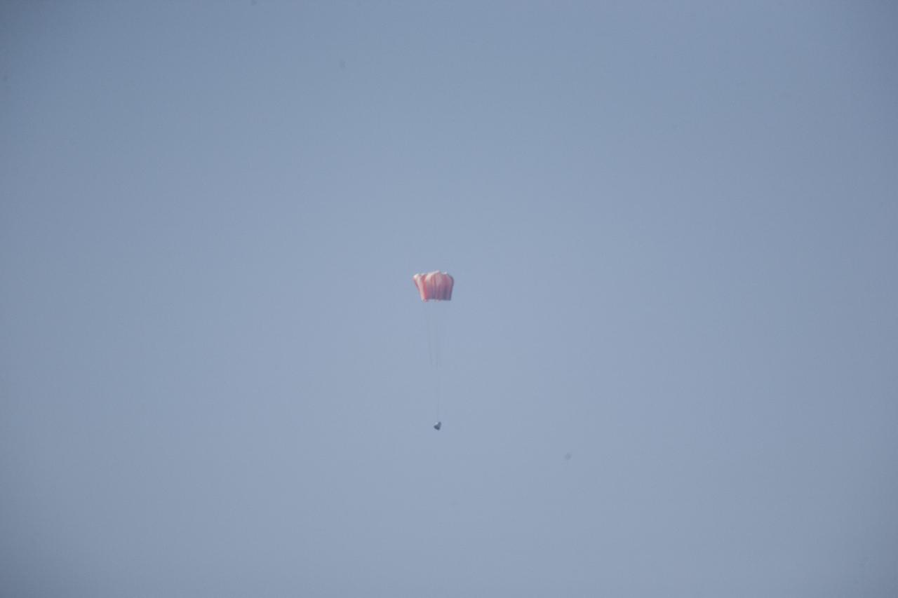 MORRO BAY, Calif. – The main parachutes open above a the Dragon test article during a test over the Pacific Ocean, off the coast of Morro Bay, Calif. The test enabled SpaceX engineers to evaluate the spacecraft's parachute deployment system as part of a milestone under its Commercial Crew Integrated Capability agreement with NASA's Commercial Crew Program. The parachute test took place at Marro Bay, Calif. Photo credit: NASA/Kim Shiflett