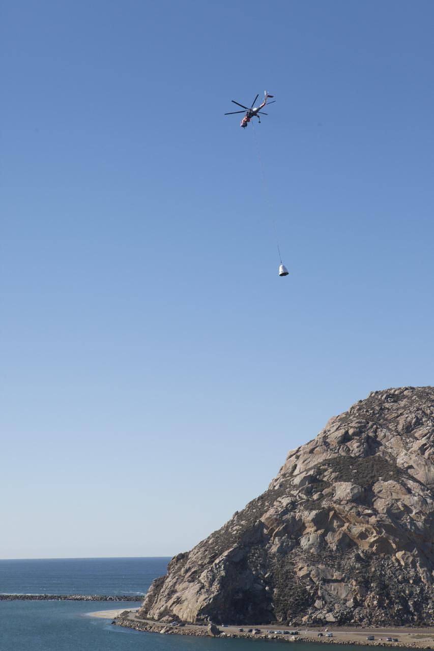 MORRO BAY, Calif. – A SpaceX Dragon test article is lifted under an Erickson Sky Crane helicopter before a test to evaluate the spacecraft's parachute deployment system as part of a milestone achievement under its Commercial Crew Integrated Capability agreement with NASA's Commercial Crew Program. The parachute test took place over the Pacific Ocean, off the coast of Morro Bay, Calif. Photo credit: NASA/Kim Shiflett