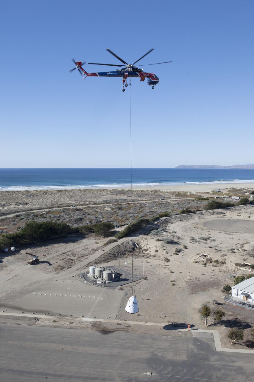 MORRO BAY, Calif. - An Erickson Sky Crane helicopter returns the SpaceX Dragon test article to Morro Bay, Cailf., following a test to evaluate the spacecraft's parachute deployment system. The test was part of a milestone under its Commercial Crew Integrated Capability agreement  with NASA's Commercial Crew Program. Photo credit: NASA/Kim Shiflett
