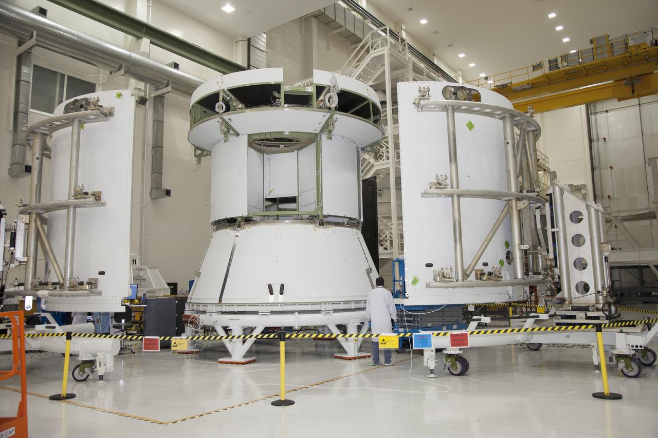 CAPE CANAVERAL, Fla. – Inside the Operations and Checkout Building high bay at NASA’s Kennedy Space Center in Florida, the service module for the Orion spacecraft is secured to a work stand and is being prepared for fairing installation. To the right and left are two of the three fairings that will be installed around the service module. The Orion spacecraft is being prepared for its first unpiloted flight test, Exploration Flight Test-1, or EFT-1, scheduled for launch atop a Delta IV rocket in September 2014. The Orion spacecraft is designed to carry astronauts to destinations not yet explored by humans. It will have emergency abort capability, sustain the crew during space travel and provide safe re-entry from deep space return velocities. Orion is scheduled to launch atop NASA’s Space Launch System rocket in 2017. For more information, visit http://www.nasa.gov/orion. Photo credit: NASA/Daniel Casper