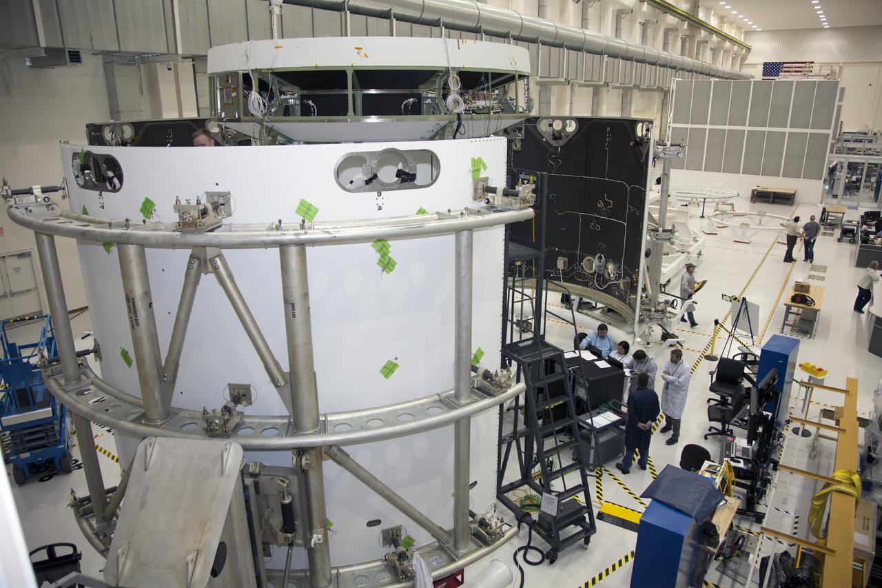CAPE CANAVERAL, Fla. – Inside the Operations and Checkout Building high bay at NASA’s Kennedy Space Center in Florida, the service module for the Orion spacecraft is secured to a work stand. Technicians are preparing the three fairings for installation around the service module.      The Orion spacecraft is being prepared for its first unpiloted flight test, Exploration Flight Test-1, or EFT-1, scheduled for launch atop a Delta IV rocket in September 2014. The Orion spacecraft is designed to carry astronauts to destinations not yet explored by humans. It will have emergency abort capability, sustain the crew during space travel and provide safe re-entry from deep space return velocities. Orion is scheduled to launch atop NASA’s Space Launch System rocket in 2017. For more information, visit http://www.nasa.gov/orion. Photo credit: NASA/Daniel Casper