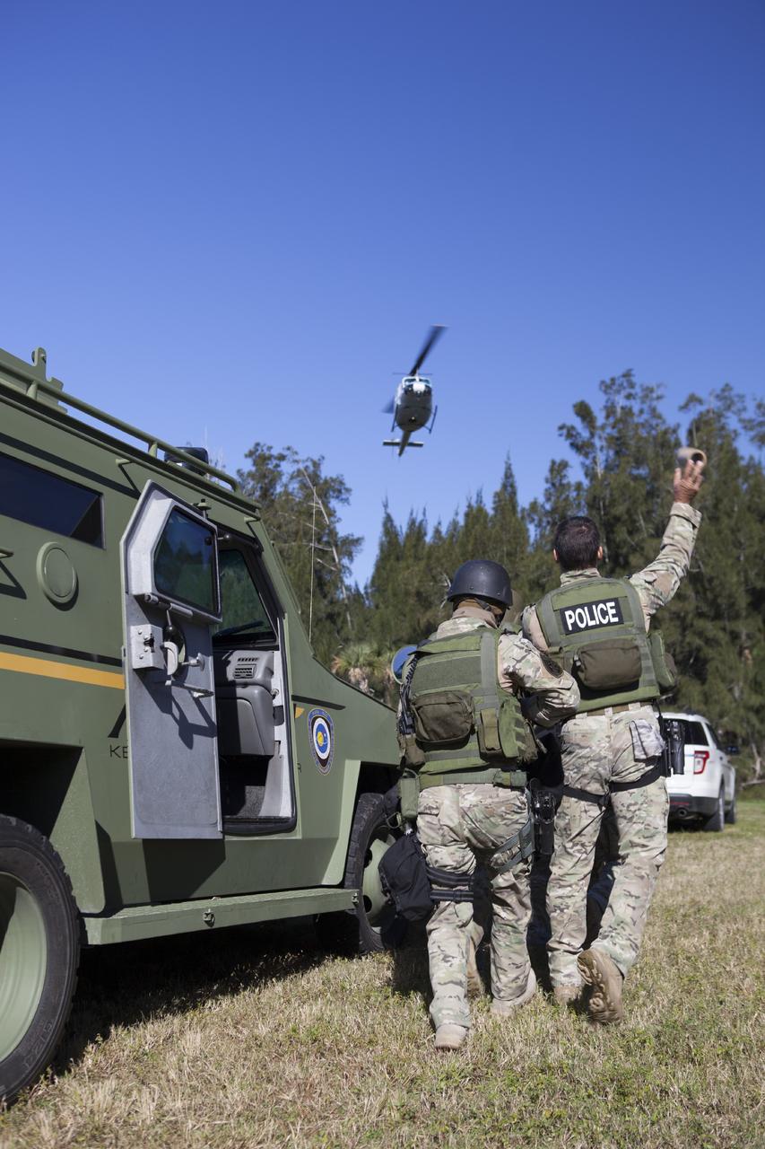 CAPE CANAVERAL, Fla. – At NASA’s Protective Services Training Academy at Kennedy Space Center in Florida, a member of the Emergency Response Team, or ERT, tosses a flash bang diversionary device during a specialized training simulation as a helicopter hovers above. The ERT members are wearing full protective gear and carrying non-lethal firearms for the training exercises in order to keep their skills current.    Recently, eight members of the ERT competed in the 31st Annual SWAT Roundup International competition in Orlando, Fla., and received recognition by placing in the top five overall.  In keeping with NASA’s commitment to safety and security of workforce and assets, the ERT is part of Kennedy’s security team and is trained to respond in the event of an emergency at the center.  Photo credit: NASA/Dimitri Gerondidakis
