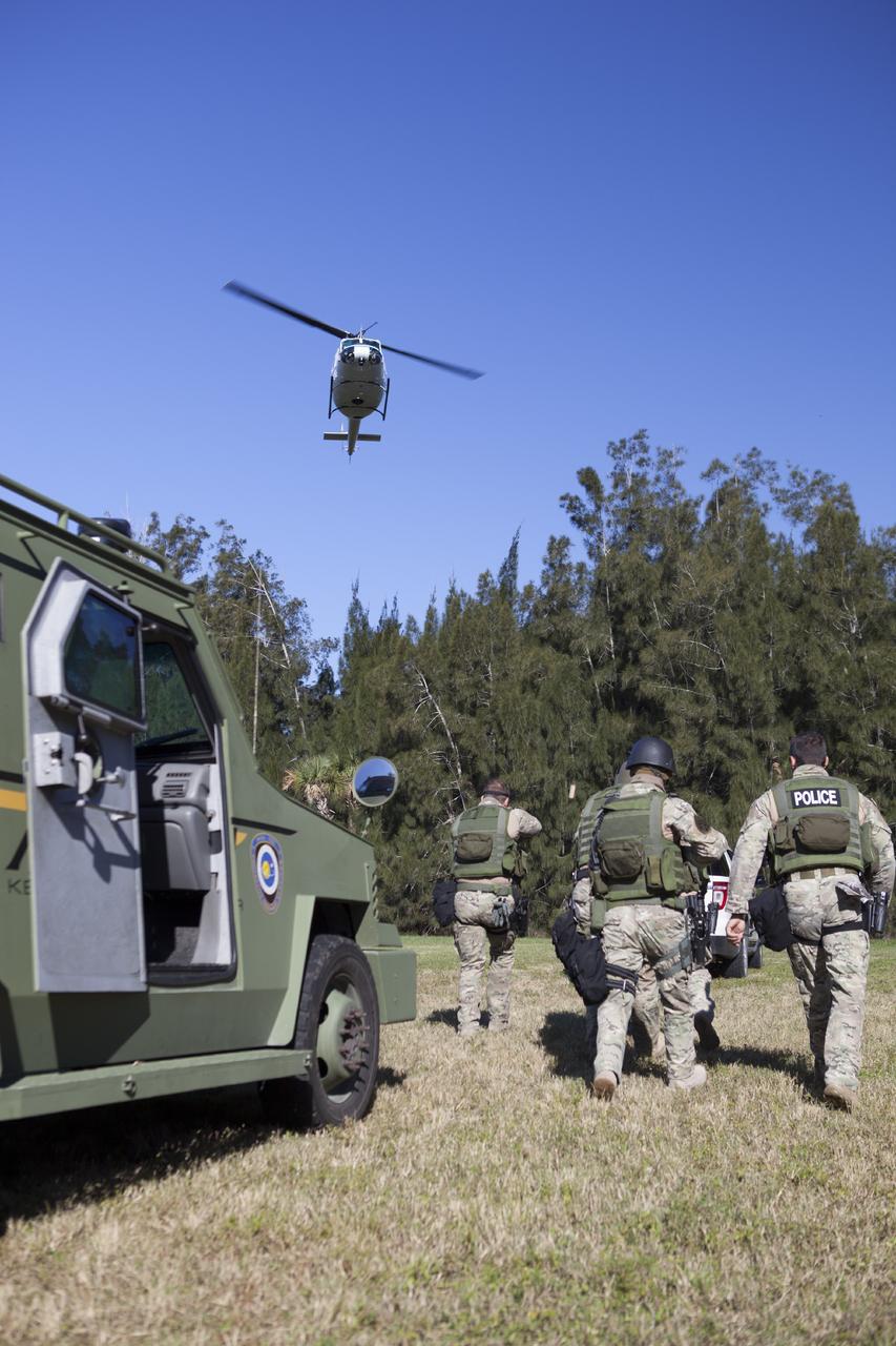 CAPE CANAVERAL, Fla. – At NASA’s Protective Services Training Academy at Kennedy Space Center in Florida, members of the Emergency Response Team, or ERT, participate in specialized training simulations as a helicopter hovers above. They are wearing full protective gear and carrying non-lethal firearms for the training exercises in order to keep their skills current.    Recently, eight members of the ERT competed in the 31st Annual SWAT Roundup International competition in Orlando, Fla., and received recognition by placing in the top five overall.  In keeping with NASA’s commitment to safety and security of workforce and assets, the ERT is part of Kennedy’s security team and is trained to respond in the event of an emergency at the center.  Photo credit: NASA/Dimitri Gerondidakis