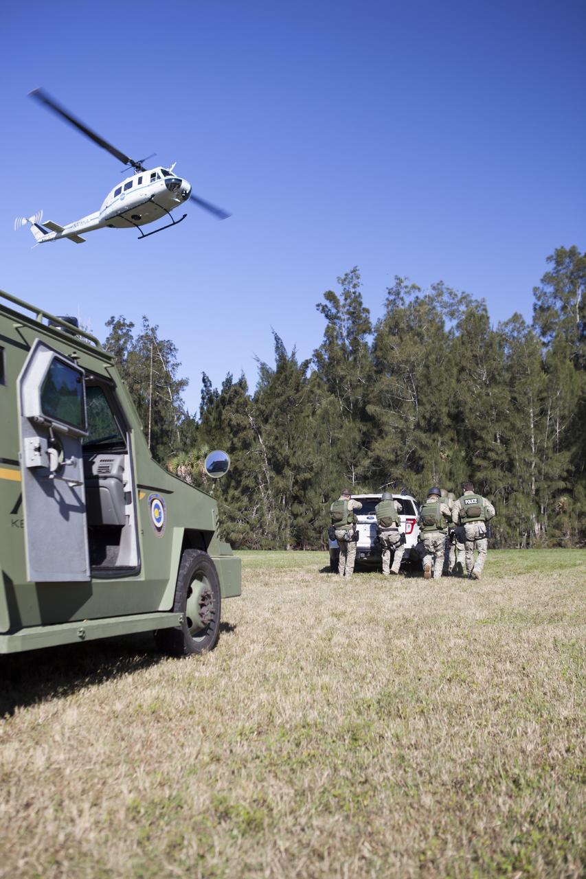 CAPE CANAVERAL, Fla. – At NASA’s Protective Services Training Academy at Kennedy Space Center in Florida, a helicopter hovers above members of the Emergency Response Team, or ERT, as they participate in specialized training simulations. They are wearing full protective gear and carrying non-lethal firearms for the training exercises in order to keep their skills current.    Recently, eight members of the ERT competed in the 31st Annual SWAT Roundup International competition in Orlando, Fla., and received recognition by placing in the top five overall.  In keeping with NASA’s commitment to safety and security of workforce and assets, the ERT is part of Kennedy’s security team and is trained to respond in the event of an emergency at the center.  Photo credit: NASA/Dimitri Gerondidakis