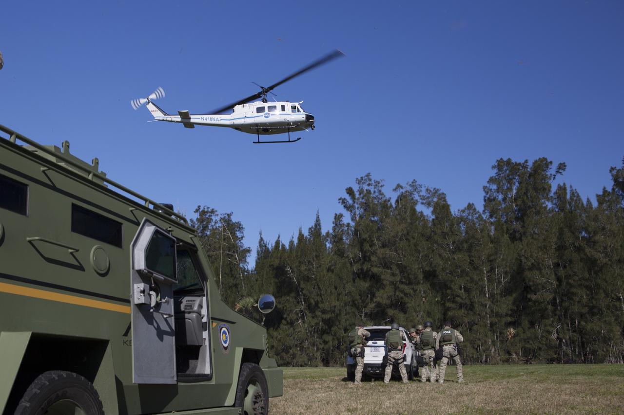 CAPE CANAVERAL, Fla. – At NASA’s Protective Services Training Academy at Kennedy Space Center in Florida, a helicopter hovers above members of the Emergency Response Team, or ERT, as they participate in specialized training simulations. They are wearing full protective gear and carrying non-lethal firearms for the training exercises in order to keep their skills current.    Recently, eight members of the ERT competed in the 31st Annual SWAT Roundup International competition in Orlando, Fla., and received recognition by placing in the top five overall.  In keeping with NASA’s commitment to safety and security of workforce and assets, the ERT is part of Kennedy’s security team and is trained to respond in the event of an emergency at the center.  Photo credit: NASA/Dimitri Gerondidakis