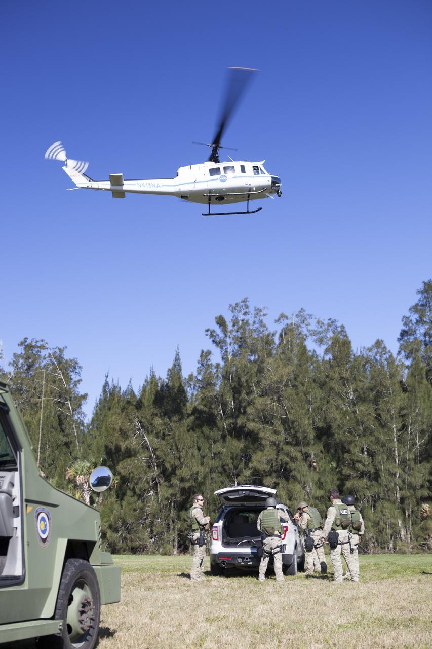 CAPE CANAVERAL, Fla. – At NASA’s Protective Services Training Academy at Kennedy Space Center in Florida, a helicopter hovers above members of the Emergency Response Team, or ERT, as they participate in specialized training simulations. They are wearing full protective gear and carrying non-lethal firearms for the training exercises in order to keep their skills current.    Recently, eight members of the ERT competed in the 31st Annual SWAT Roundup International competition in Orlando, Fla., and received recognition by placing in the top five overall.  In keeping with NASA’s commitment to safety and security of workforce and assets, the ERT is part of Kennedy’s security team and is trained to respond in the event of an emergency at the center.  Photo credit: NASA/Dimitri Gerondidakis