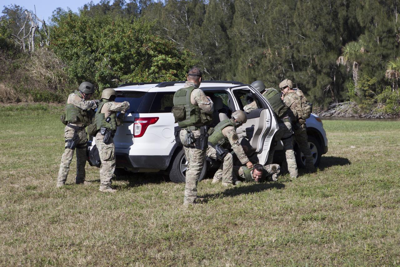 CAPE CANAVERAL, Fla. – At NASA’s Protective Services Training Academy at Kennedy Space Center in Florida, members of the Emergency Response Team, or ERT, participate in specialized training simulations in order to keep their skills current. They are wearing full protective gear and carrying non-lethal firearms, which are denoted in blue, for the training exercises.    Recently, eight members of the ERT competed in the 31st Annual SWAT Roundup International competition in Orlando, Fla., and received recognition by placing in the top five overall.  In keeping with NASA’s commitment to safety and security of workforce and assets, the ERT is part of Kennedy’s security team and is trained to respond in the event of an emergency at the center.  Photo credit: NASA/Dimitri Gerondidakis
