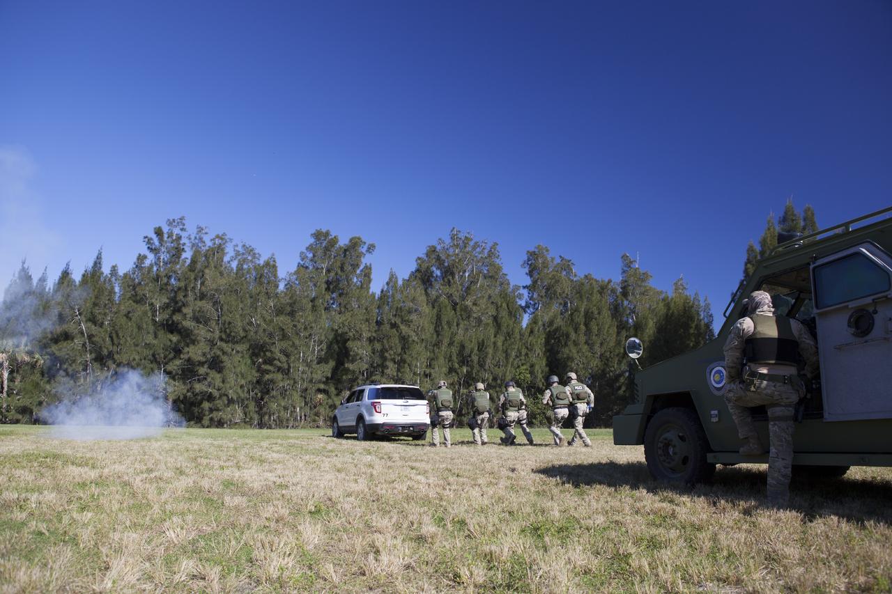 CAPE CANAVERAL, Fla. – At NASA’s Protective Services Training Academy at Kennedy Space Center in Florida, members of the Emergency Response Team, or ERT, participate in specialized training simulations which includes the use of flash bang diversionary devices. They are wearing full protective gear and carrying non-lethal firearms for the training exercises in order to keep their skills current.    Recently, eight members of the ERT competed in the 31st Annual SWAT Roundup International competition in Orlando, Fla., and received recognition by placing in the top five overall.  In keeping with NASA’s commitment to safety and security of workforce and assets, the ERT is part of Kennedy’s security team and is trained to respond in the event of an emergency at the center.  Photo credit: NASA/Dimitri Gerondidakis
