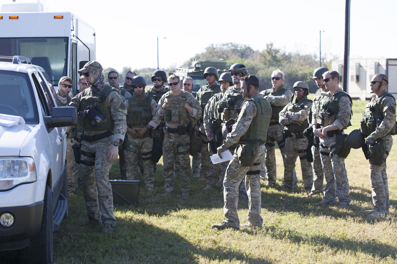 CAPE CANAVERAL, Fla. – At NASA’s Protective Services Training Academy at Kennedy Space Center in Florida, some members of the Emergency Response Team, or ERT, gather to review specialized training simulations in order to keep their skills current. They are wearing full protective gear and carrying non-lethal firearms, denoted in blue, for the training exercises.    Recently, eight members of the ERT competed in the 31st Annual SWAT Roundup International competition in Orlando, Fla., and received recognition by placing in the top five overall.  In keeping with NASA’s commitment to safety and security of workforce and assets, the ERT is part of Kennedy’s security team and is trained to respond in the event of an emergency at the center.  Photo credit: NASA/Dimitri Gerondidakis