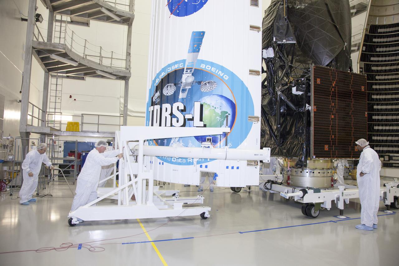 TITUSVILLE, Fla. – Inside the Astrotech payload processing facility in Titusville, NASA's Tracking and Data Relay Satellite, or TDRS-L, spacecraft is being encapsulated in its payload fairing in preparation for begin transported to Launch Complex 41 at Cape Canaveral Air Force Station. The TDRS-L satellite will be a part of the second of three next-generation spacecraft designed to ensure vital operational continuity for the NASA Space Network. It is scheduled to launch from Cape Canaveral's Space Launch Complex 41 atop a United Launch Alliance Atlas V rocket on January 23, 2014. The current Tracking and Data Relay Satellite system consists of eight in-orbit satellites distributed to provide near continuous information relay contact with orbiting spacecraft ranging from the International Space Station and Hubble Space Telescope to the array of scientific observatories. For more information, visit: http://www.nasa.gov/mission_pages/tdrs/home/index.html