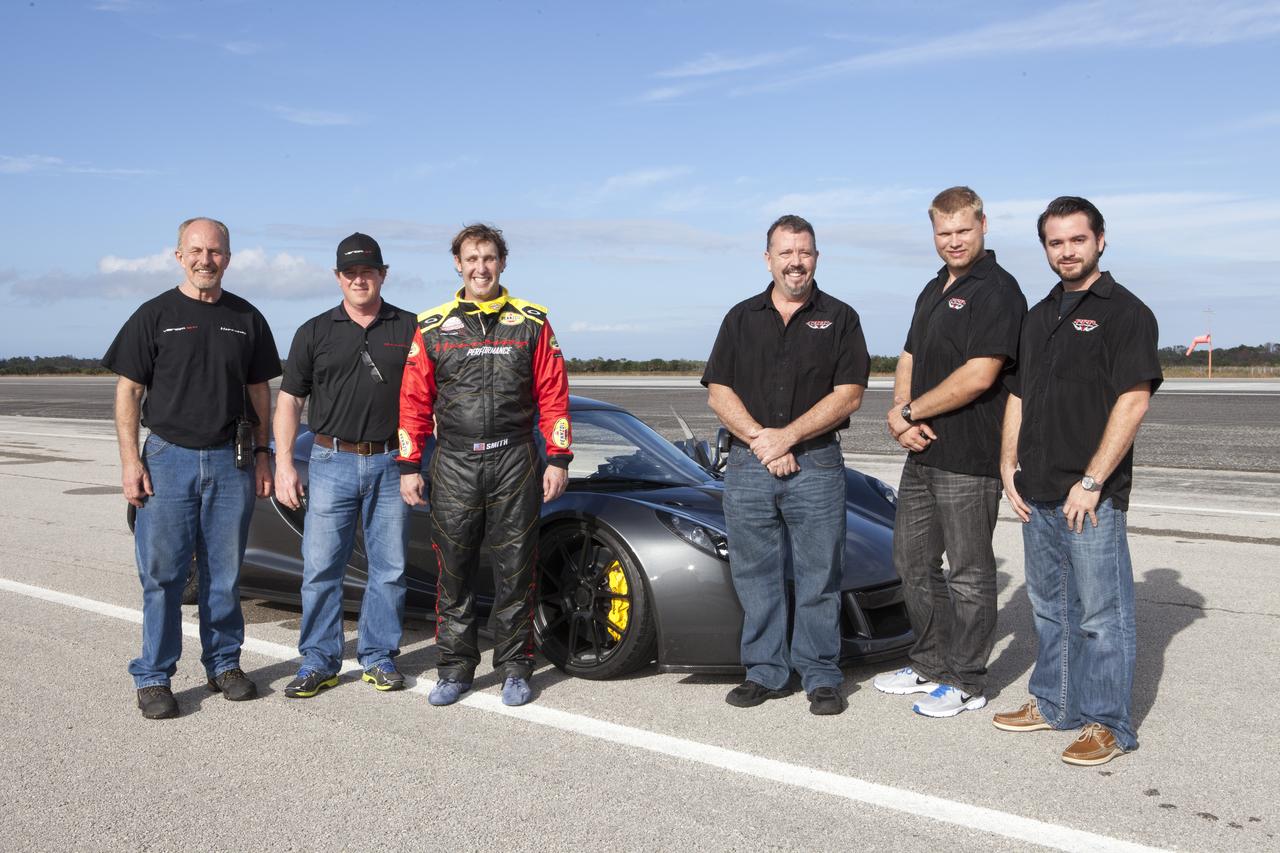 CAPE CANAVERAL, Fla. - The Performance Power Racing and Hennessey Performance teams pose with a Hennessey Venom GT at the 3.5-mile long runway at the Shuttle Landing Facility at NASA's Kennedy Space Center in Florida. The teams are, from left, Hennessey's John Heinricy, John Hennessey, Brian Smith, Performance Power Racing's Johnny Bohmer, Matt Lundy and Jeff McEachran. The flat concrete runway is one of the few places in the world where high performance automobiles can be tested for aerodynamic and safety designs. Hennessey Performance of Sealy, Texas, worked with Performance Power Racing in West Palm Beach to arrange use of the NASA facility. Performance Power Racing has conducted numerous engineering tests on the runway with a variety of vehicles.