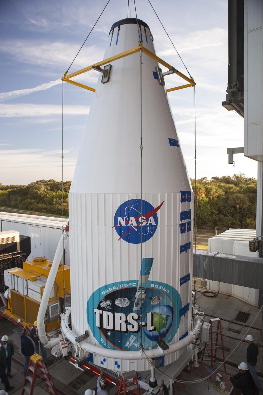 CAPE CANAVERAL, Fla. – At Cape Canaveral Air Force Station's Vertical Integration Facility at Launch Complex 41, engineers and technicians begin lifting NASA's Tracking and Data Relay Satellite, or TDRS-L, spacecraft for mounting atop a United Launch Alliance Atlas V rocket. The TDRS-L satellite will be a part of the second of three next-generation spacecraft designed to ensure vital operational continuity for the NASA Space Network. It is scheduled to launch from Cape Canaveral's Space Launch Complex 41 atop a United Launch Alliance Atlas V rocket on Jan. 23, 2014. The current Tracking and Data Relay Satellite system consists of eight in-orbit satellites distributed to provide near continuous information relay contact with orbiting spacecraft ranging from the International Space Station and Hubble Space Telescope to the array of scientific observatories. For more information, visit: http://www.nasa.gov/mission_pages/tdrs/home/index.html Photo credit: NASA/Dimitri Gerondidakis