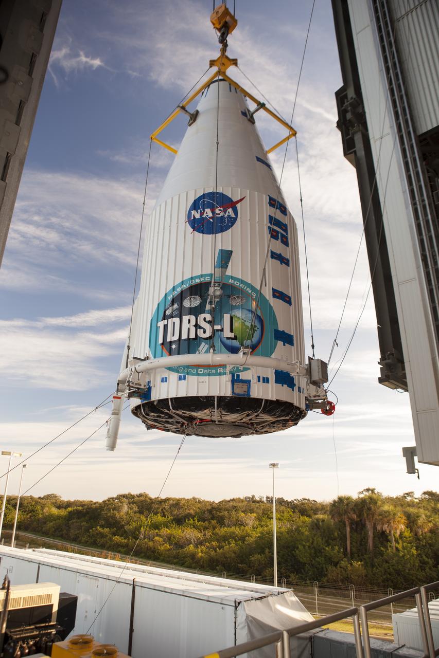 CAPE CANAVERAL, Fla. – At Cape Canaveral Air Force Station's Vertical Integration Facility at Launch Complex 41, engineers and technicians begin lifting NASA's Tracking and Data Relay Satellite, or TDRS-L, spacecraft for mounting atop a United Launch Alliance Atlas V rocket. The TDRS-L satellite will be a part of the second of three next-generation spacecraft designed to ensure vital operational continuity for the NASA Space Network. It is scheduled to launch from Cape Canaveral's Space Launch Complex 41 atop a United Launch Alliance Atlas V rocket on Jan. 23, 2014. The current Tracking and Data Relay Satellite system consists of eight in-orbit satellites distributed to provide near continuous information relay contact with orbiting spacecraft ranging from the International Space Station and Hubble Space Telescope to the array of scientific observatories. For more information, visit: http://www.nasa.gov/mission_pages/tdrs/home/index.html Photo credit: NASA/Dimitri Gerondidakis