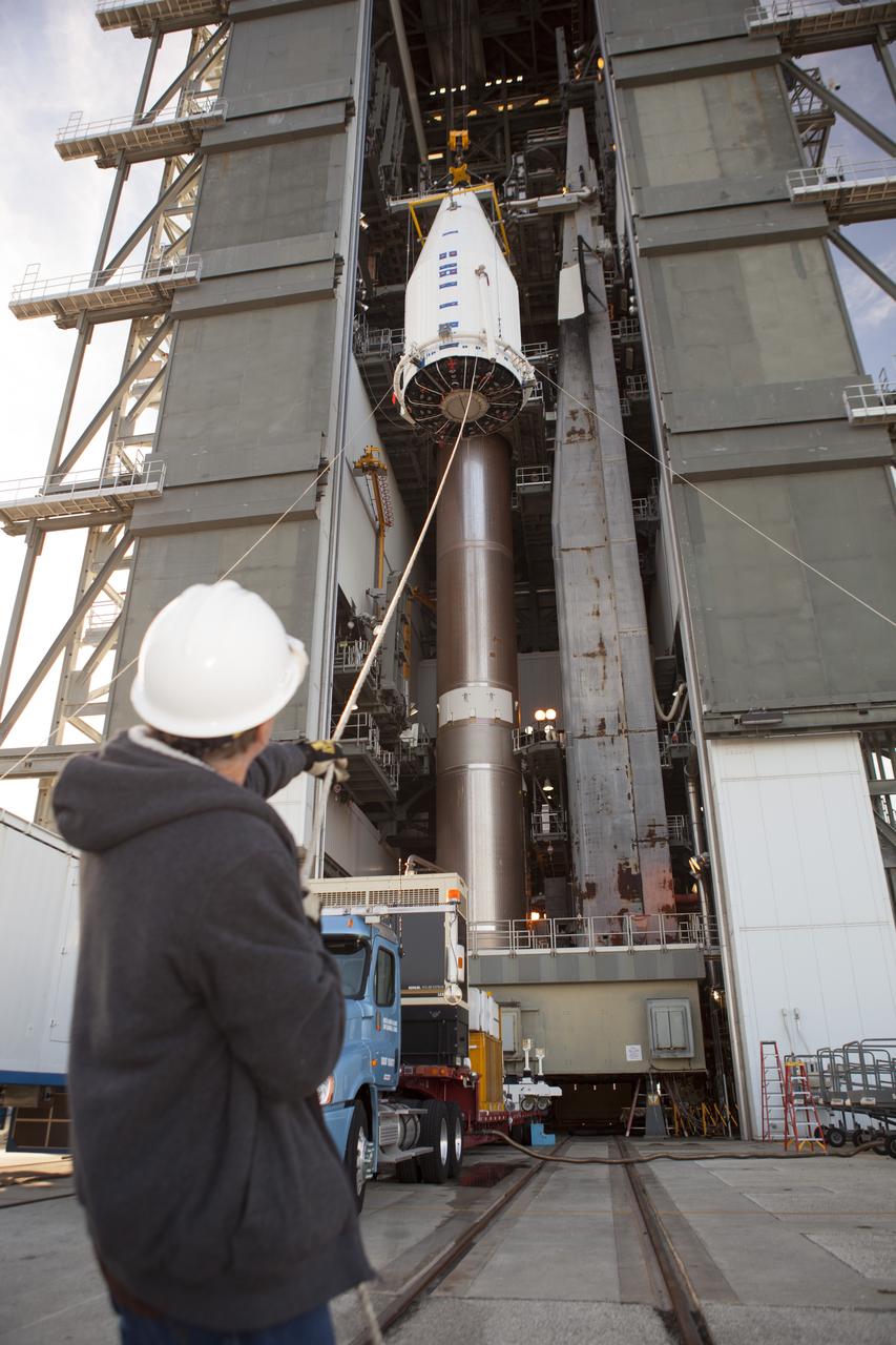 CAPE CANAVERAL, Fla. – At Cape Canaveral Air Force Station's Vertical Integration Facility at Launch Complex 41, a technician uses a support line to steady NASA's Tracking and Data Relay Satellite, or TDRS-L, spacecraft as it is lifted for mounting atop a United Launch Alliance Atlas V rocket. The TDRS-L satellite will be a part of the second of three next-generation spacecraft designed to ensure vital operational continuity for the NASA Space Network. It is scheduled to launch from Cape Canaveral's Space Launch Complex 41 atop a United Launch Alliance Atlas V rocket on Jan. 23, 2014. The current Tracking and Data Relay Satellite system consists of eight in-orbit satellites distributed to provide near continuous information relay contact with orbiting spacecraft ranging from the International Space Station and Hubble Space Telescope to the array of scientific observatories. For more information, visit: http://www.nasa.gov/mission_pages/tdrs/home/index.html Photo credit: NASA/Dimitri Gerondidakis
