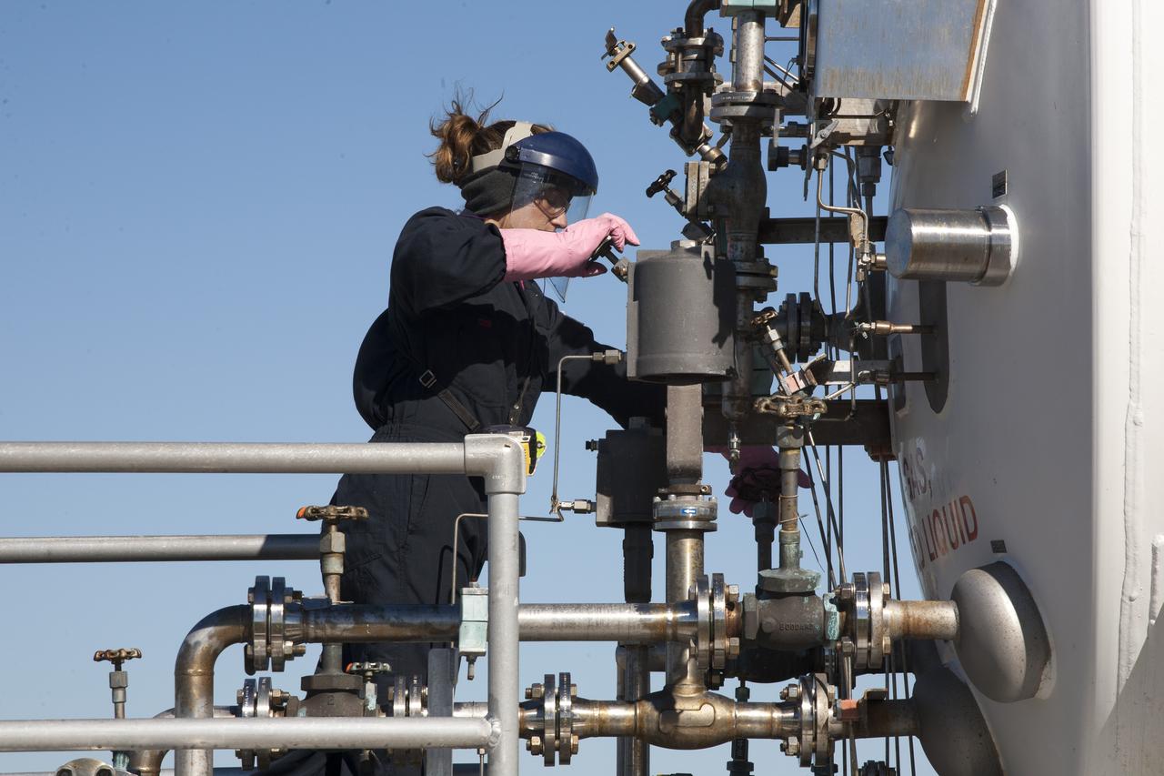 CAPE CANAVERAL, Fla. – A technician monitors the flow of propellant loading in the Project Morpheus prototype lander as it is prepared for its third free flight test at the north end of the Shuttle Landing Facility at NASA’s Kennedy Space Center in Florida. The 57-second test began at 1:15 p.m. EST with the Morpheus lander launching from the ground over a flame trench and ascending about 187 feet, nearly doubling the target ascent velocity from the last test in December 2013. The lander flew forward, covering about 154 feet in 20 seconds before descending and landing within 11 inches of its target on a dedicated pad inside the autonomous landing and hazard avoidance technology, or ALHAT, hazard field. Project Morpheus tests NASA’s ALHAT and an engine that runs on liquid oxygen and methane, or green propellants, into a fully-operational lander that could deliver cargo to other planetary surfaces. The landing facility provides the lander with the kind of field necessary for realistic testing, complete with rocks, craters and hazards to avoid. Morpheus’ ALHAT payload allows it to navigate to clear landing sites amidst rocks, craters and other hazards during its descent. Project Morpheus is being managed under the Advanced Exploration Systems, or AES, Division in NASA’s Human Exploration and Operations Mission Directorate. The efforts in AES pioneer new approaches for rapidly developing prototype systems, demonstrating key capabilities and validating operational concepts for future human missions beyond Earth orbit. For more information on Project Morpheus, visit http://www.nasa.gov/centers/johnson/exploration/morpheus. Photo credit: NASA/Kim Shiflett  