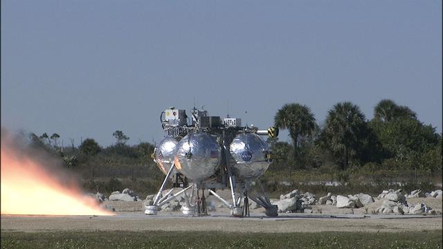 CAPE CANAVERAL, Fla. – The Project Morpheus prototype lander third free flight test begins at the north end of the Shuttle Landing Facility at NASA’s Kennedy Space Center in Florida. The 57-second test began at 1:15 p.m. EST with the Morpheus lander launching from the ground over a flame trench and ascending about 187 feet, nearly doubling the target ascent velocity from the last test in December 2013. The lander flew forward, covering about 154 feet in 20 seconds before descending and landing within 11 inches of its target on a dedicated pad inside the autonomous landing and hazard avoidance technology, or ALHAT, hazard field. Project Morpheus tests NASA’s ALHAT and an engine that runs on liquid oxygen and methane, or green propellants, into a fully-operational lander that could deliver cargo to other planetary surfaces. The landing facility provides the lander with the kind of field necessary for realistic testing, complete with rocks, craters and hazards to avoid. Morpheus’ ALHAT payload allows it to navigate to clear landing sites amidst rocks, craters and other hazards during its descent. Project Morpheus is being managed under the Advanced Exploration Systems, or AES, Division in NASA’s Human Exploration and Operations Mission Directorate. The efforts in AES pioneer new approaches for rapidly developing prototype systems, demonstrating key capabilities and validating operational concepts for future human missions beyond Earth orbit. For more information on Project Morpheus, visit http://www.nasa.gov/centers/johnson/exploration/morpheus. Photo credit: NASA/Frankie Martin