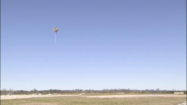 CAPE CANAVERAL, Fla. – The Project Morpheus prototype lander soars high after launching on its third free flight test at the north end of the Shuttle Landing Facility at NASA’s Kennedy Space Center in Florida. The 57-second test began at 1:15 p.m. EST with the Morpheus lander launching from the ground over a flame trench and ascending about 187 feet, nearly doubling the target ascent velocity from the last test in December 2013. The lander flew forward, covering about 154 feet in 20 seconds before descending and landing within 11 inches of its target on a dedicated pad inside the autonomous landing and hazard avoidance technology, or ALHAT, hazard field. Project Morpheus tests NASA’s ALHAT and an engine that runs on liquid oxygen and methane, or green propellants, into a fully-operational lander that could deliver cargo to other planetary surfaces. The landing facility provides the lander with the kind of field necessary for realistic testing, complete with rocks, craters and hazards to avoid. Morpheus’ ALHAT payload allows it to navigate to clear landing sites amidst rocks, craters and other hazards during its descent. Project Morpheus is being managed under the Advanced Exploration Systems, or AES, Division in NASA’s Human Exploration and Operations Mission Directorate. The efforts in AES pioneer new approaches for rapidly developing prototype systems, demonstrating key capabilities and validating operational concepts for future human missions beyond Earth orbit. For more information on Project Morpheus, visit http://www.nasa.gov/centers/johnson/exploration/morpheus. Photo credit: NASA/Frankie Martin