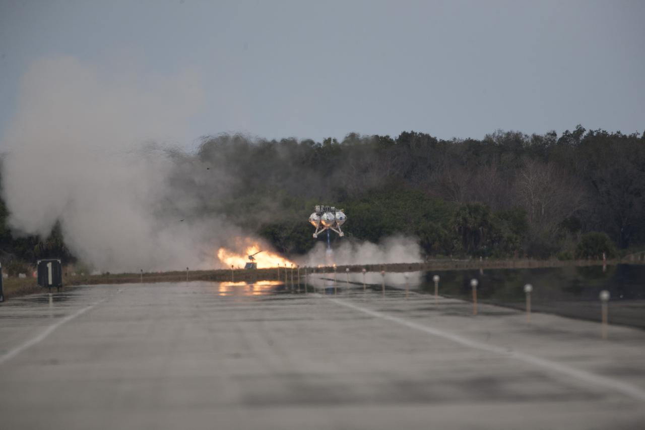 CAPE CANAVERAL, Fla. – The Project Morpheus prototype lander’s fourth free flight test begins at the north end of the Shuttle Landing Facility at NASA’s Kennedy Space Center in Florida. The 64-second test began at 1:15 p.m. EST with the Morpheus lander launching from the ground over a flame trench and ascending about 305 feet, significantly increasing the ascent velocity from the last test. The lander flew forward, covering about 358 feet in 25 seconds before descending and landing within 15 inches of its target on a dedicated pad inside the autonomous landing and hazard avoidance technology, or ALHAT, hazard field. Project Morpheus tests NASA’s ALHAT and an engine that runs on liquid oxygen and methane, or green propellants, into a fully-operational lander that could deliver cargo to other planetary surfaces. The landing facility provides the lander with the kind of field necessary for realistic testing, complete with rocks, craters and hazards to avoid. Morpheus’ ALHAT payload allows it to navigate to clear landing sites amidst rocks, craters and other hazards during its descent. Project Morpheus is being managed under the Advanced Exploration Systems, or AES, Division in NASA’s Human Exploration and Operations Mission Directorate. The efforts in AES pioneer new approaches for rapidly developing prototype systems, demonstrating key capabilities and validating operational concepts for future human missions beyond Earth orbit. For more information on Project Morpheus, visit http://www.nasa.gov/centers/johnson/exploration/morpheus. Photo credit: NASA/Kim Shiflett